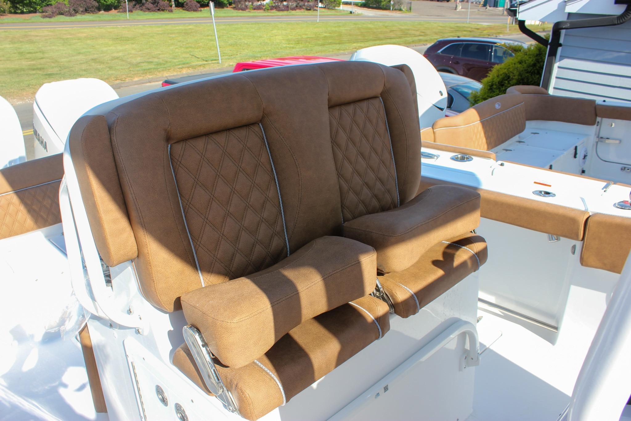 Luxurious seating on 2027 Sea Hunt Ultra 275 SE boat, featuring brown leather upholstery.