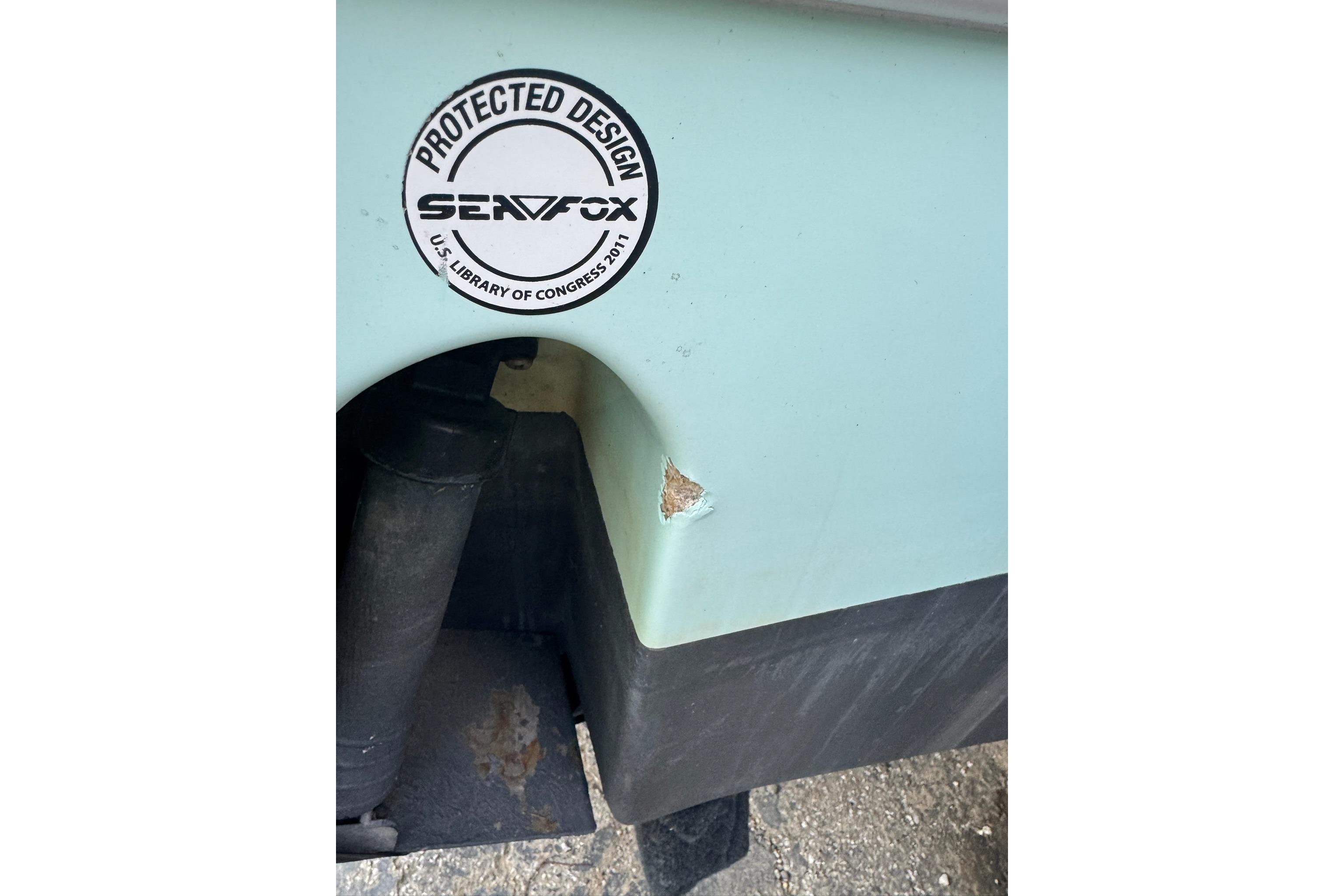 2013 Sea Fox 246 Commander boat with protected design sticker and minor hull damage.