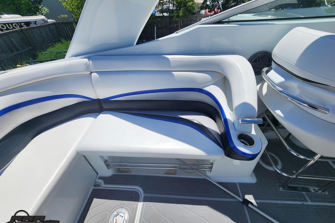 2008 Baja 335 Performance boat interior with white and blue seating, cup holder, and sleek design.