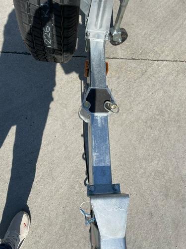2025 Spartan 185 Astoria trailer hitch and wheel on concrete surface.
