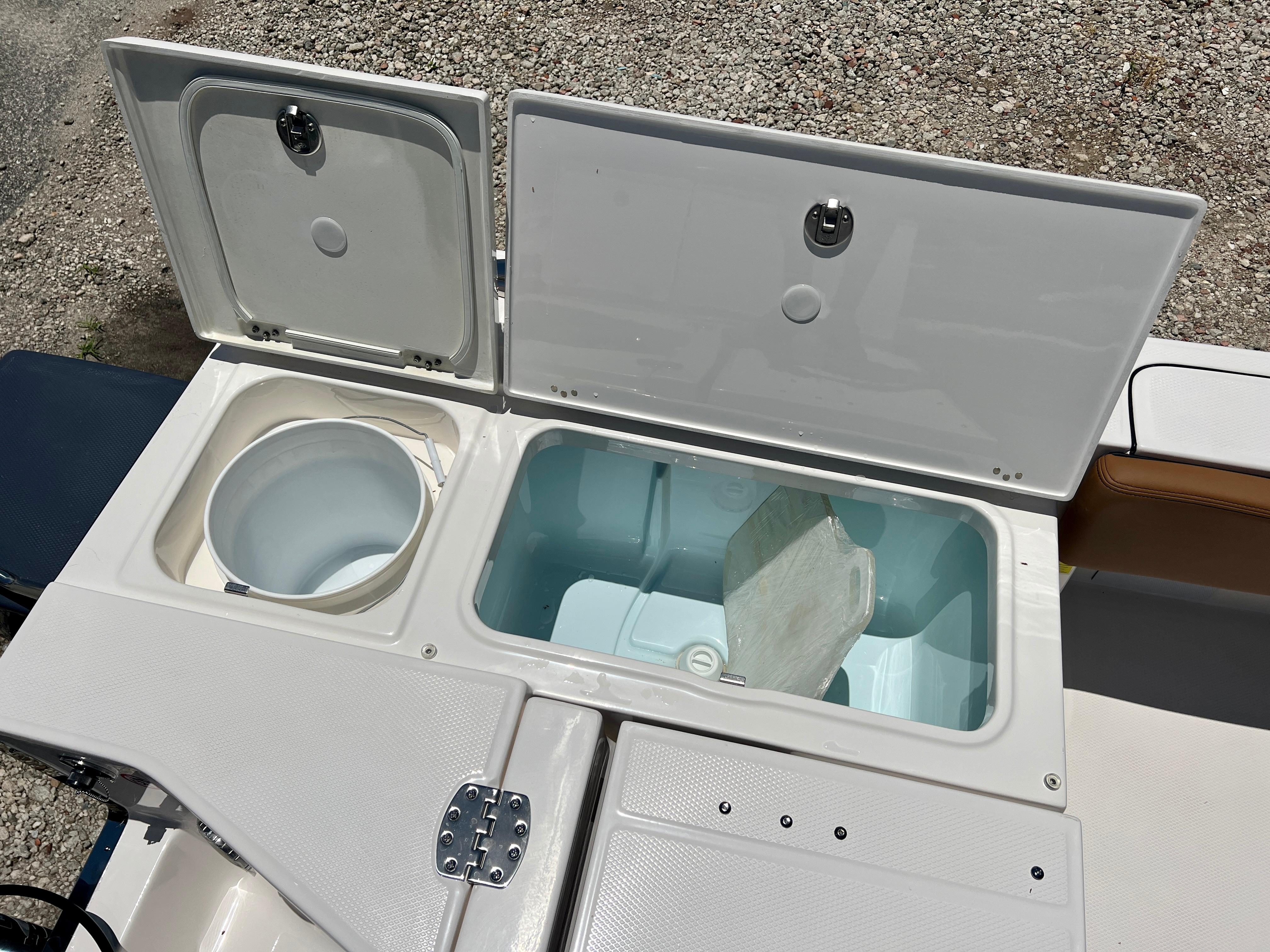 Robalo 266 Cayman 2025 boat with open storage compartments.