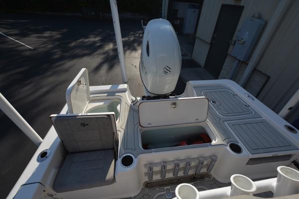 2021 Sea Pro 228 Bay boat deck with storage compartments and seating.