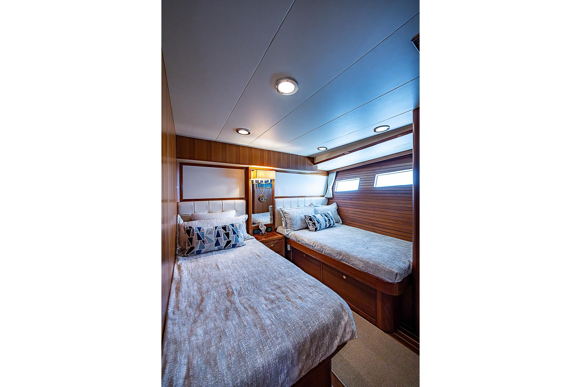 Interior cabin of 2014 Marlow 80 Explorer yacht with twin beds and modern decor.