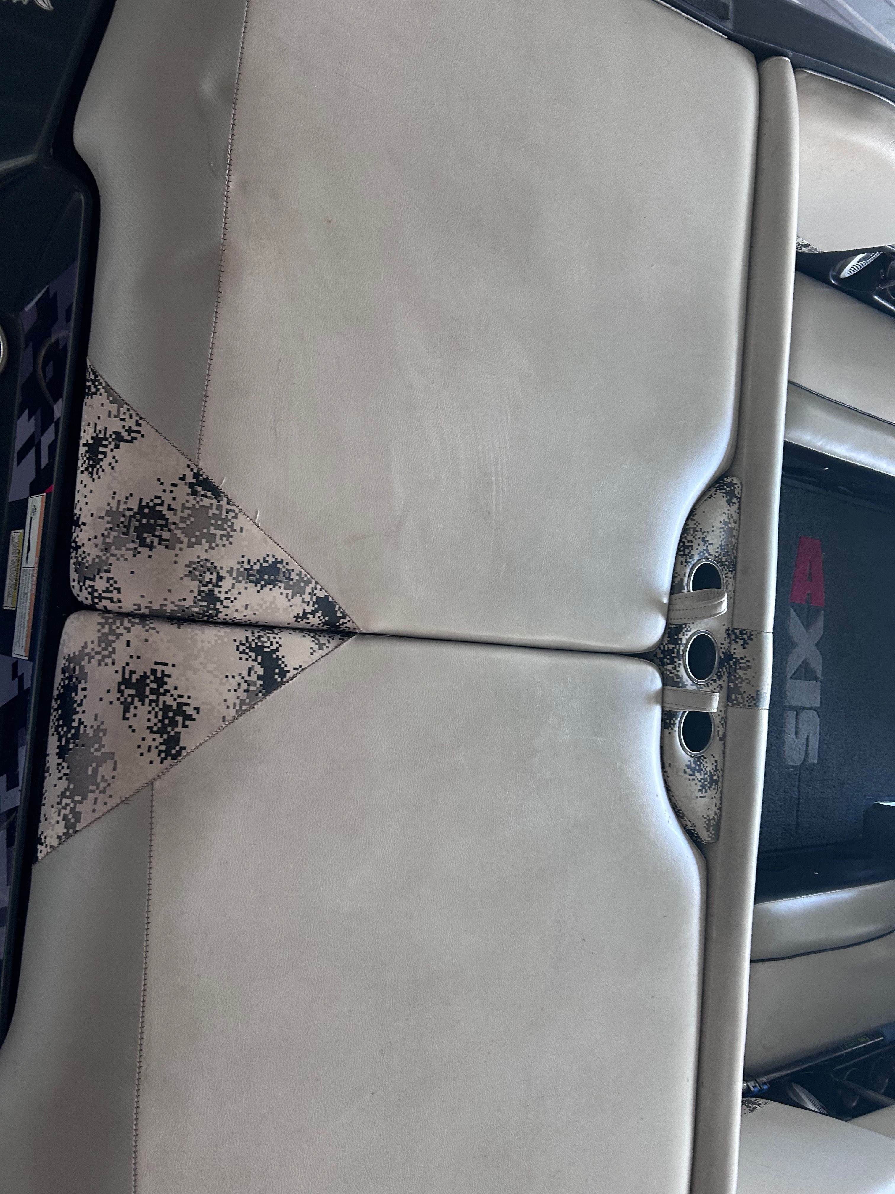 Interior of a 2013 Axis A22 boat with beige upholstery.