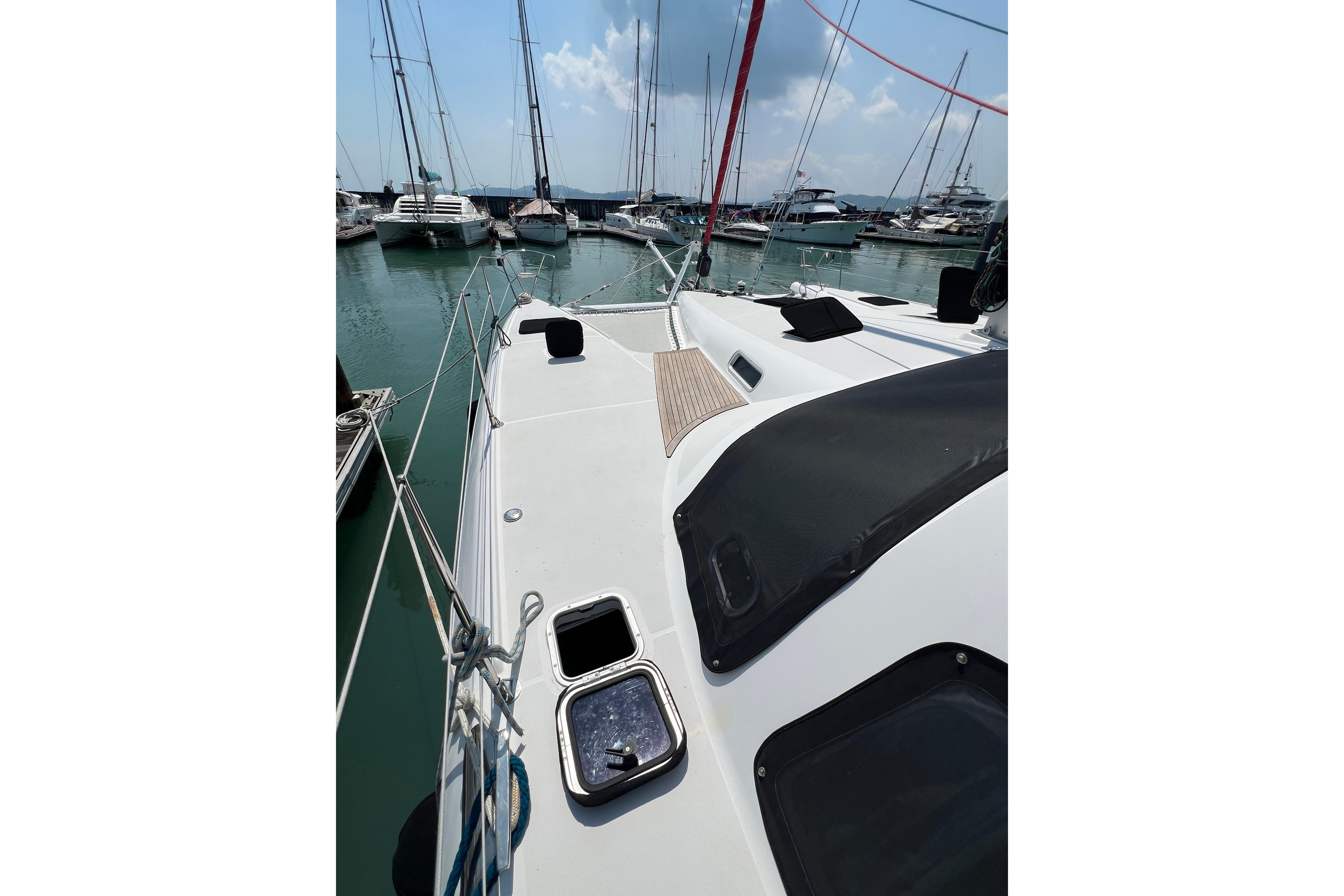 Sailing yacht Privilege 495, 2007 model, docked in a marina with other boats.