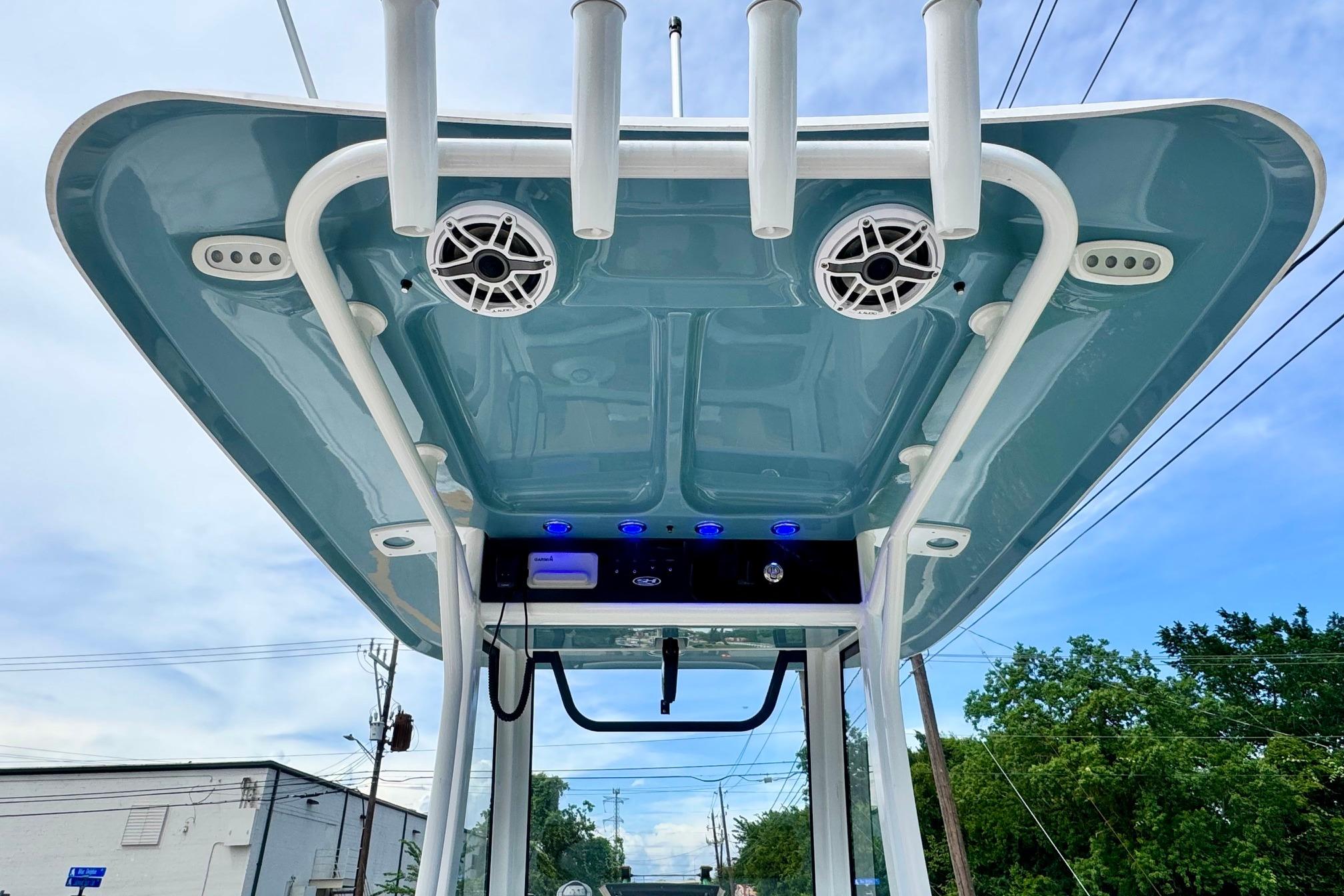 2026 Sea Hunt Ultra 275 SE boat canopy with speakers and rod holders, viewed from below.