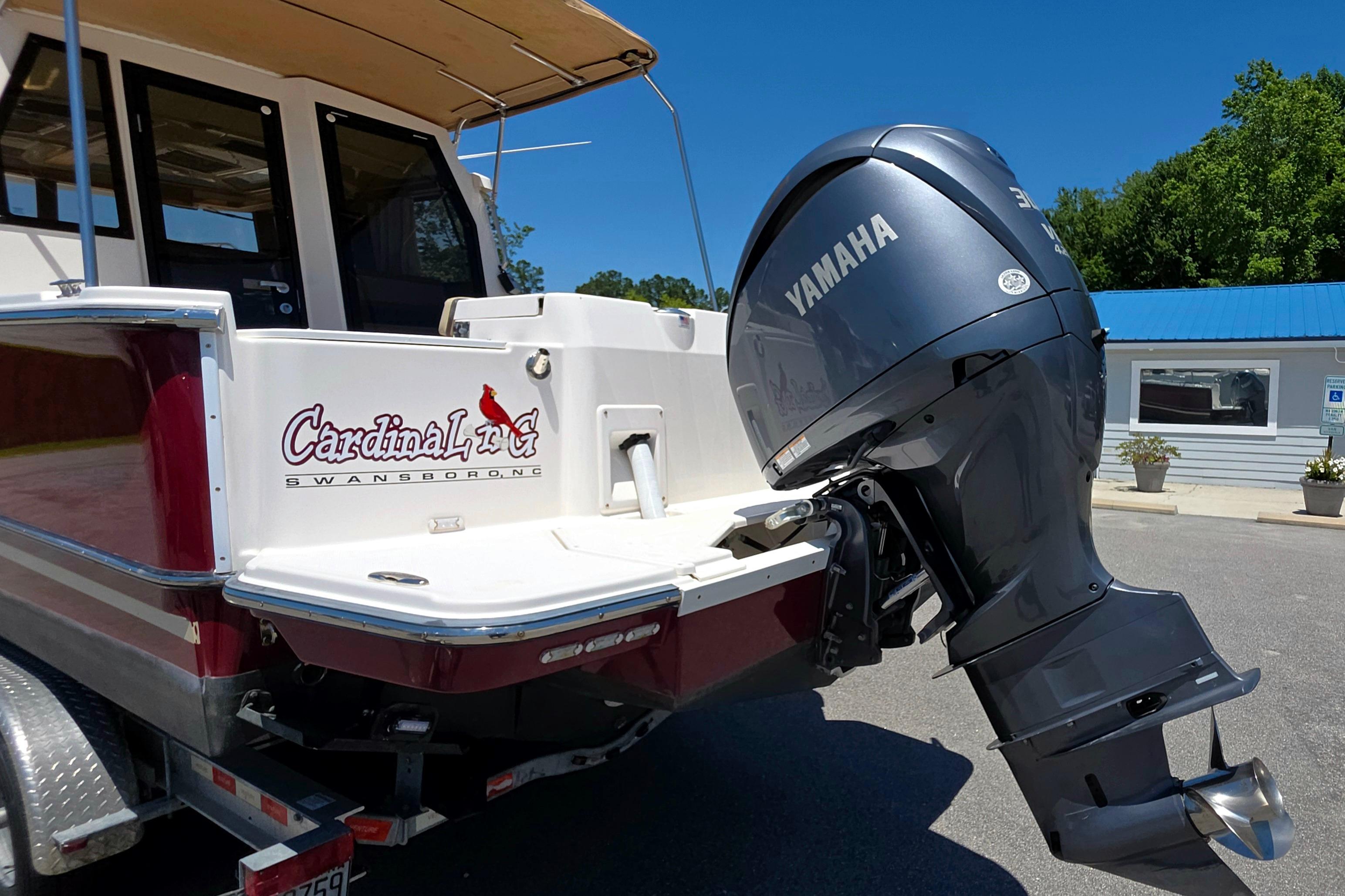 2021 Ranger Tug R27 with Yamaha outboard motor, parked outdoors.