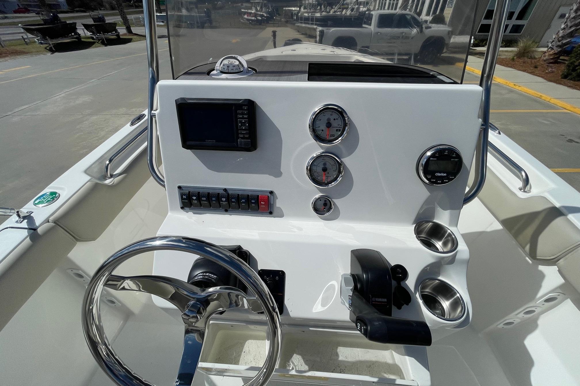 2026 Key West 203 FS boat dashboard with steering wheel, gauges, and controls.