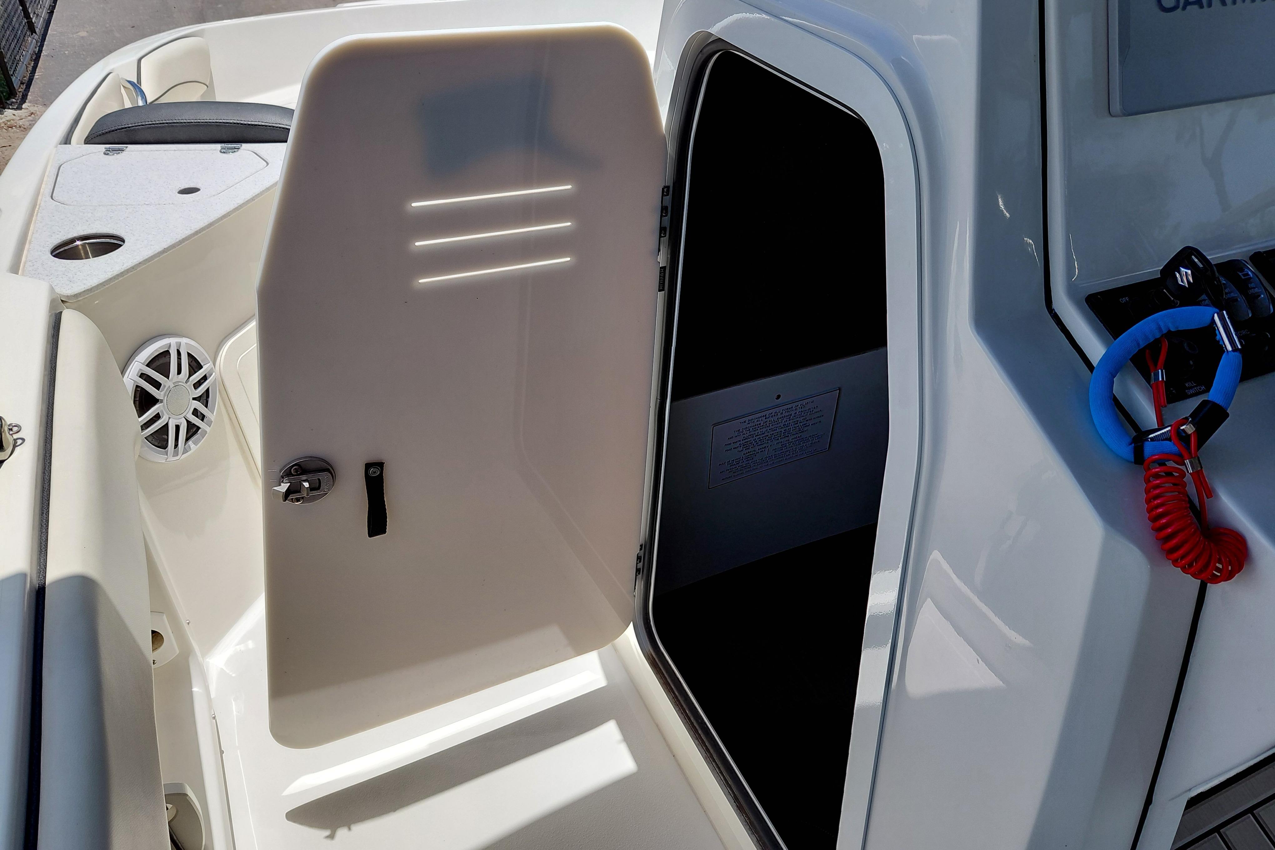2023 Stingray 206 CC boat interior with open storage compartment and safety lanyard.