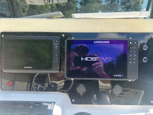 Boat dashboard with Garmin and Lowrance HDS Live displays.