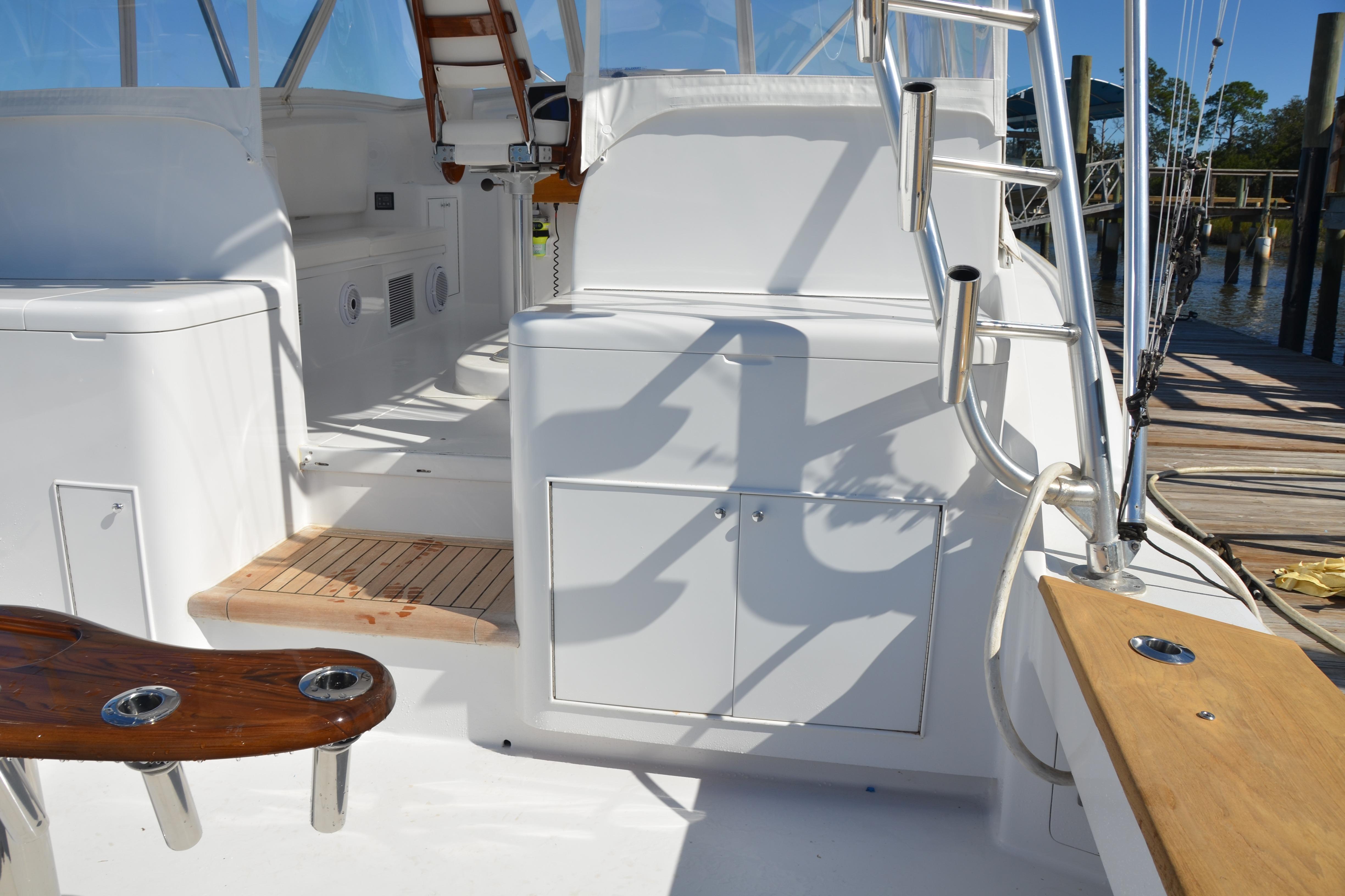 2006 Custom Carolina Heritage Express boat interior with white seating and wooden accents.