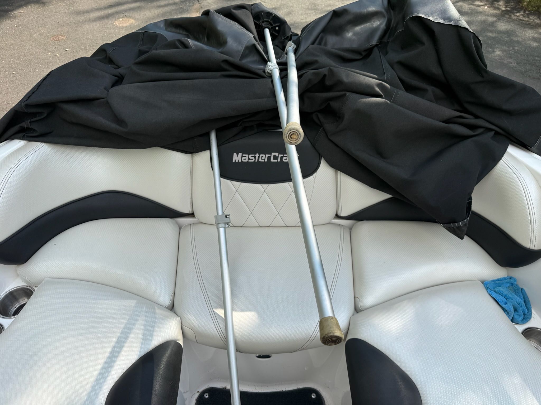 The image shows the white seating of a MasterCraft X-25 boat with black covers.