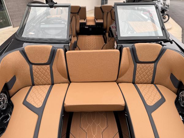 2025 Yamaha Boats 255XD interior with tan and black seating, showcasing modern design.