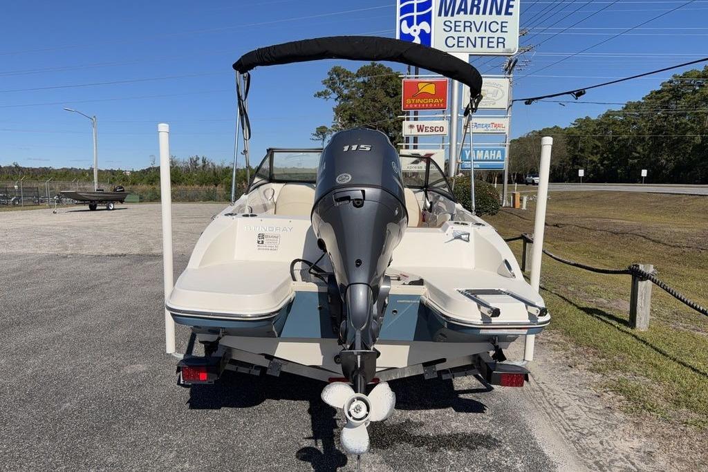 2024 Stingray 191 DC boat with outboard motor at marine service center.