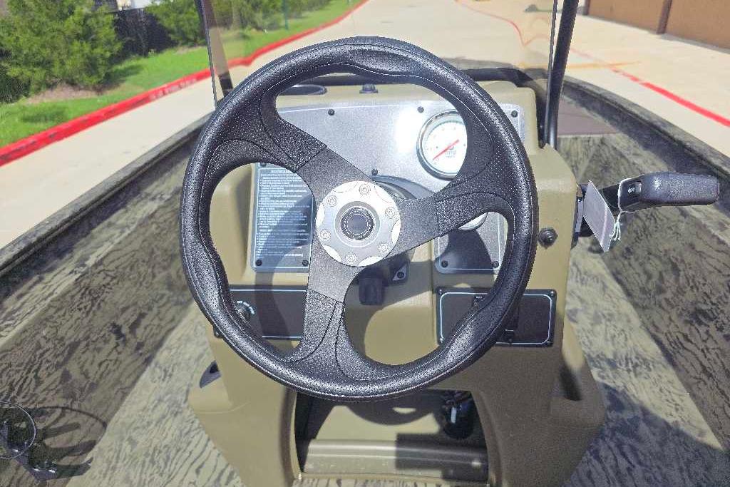 Steering wheel of 2026 Tracker Grizzly 1860 CC boat, featuring dashboard controls.