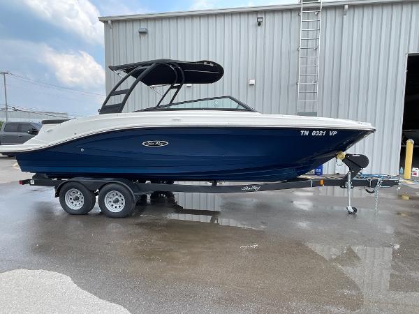 2023 Sea Ray SPX 230 boat on trailer, parked outside a building.
