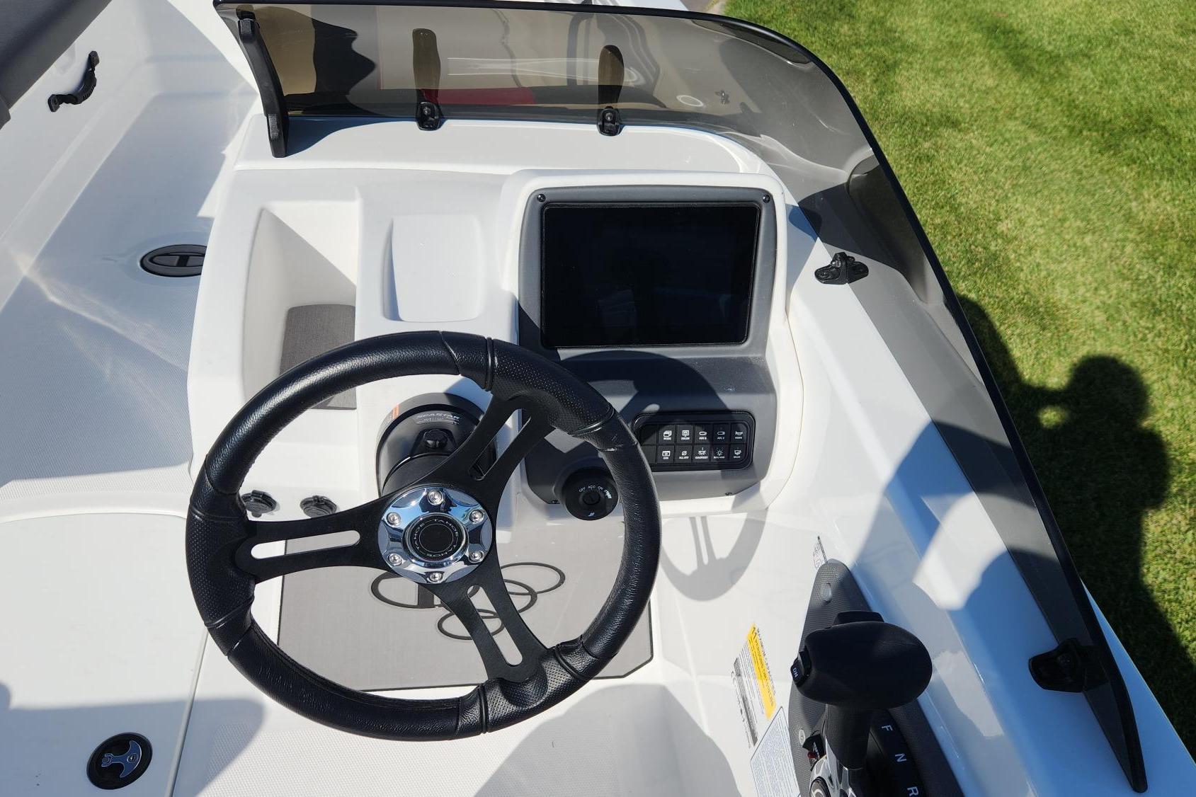 Steering console of 2026 Tahoe T21 boat with modern controls and display.