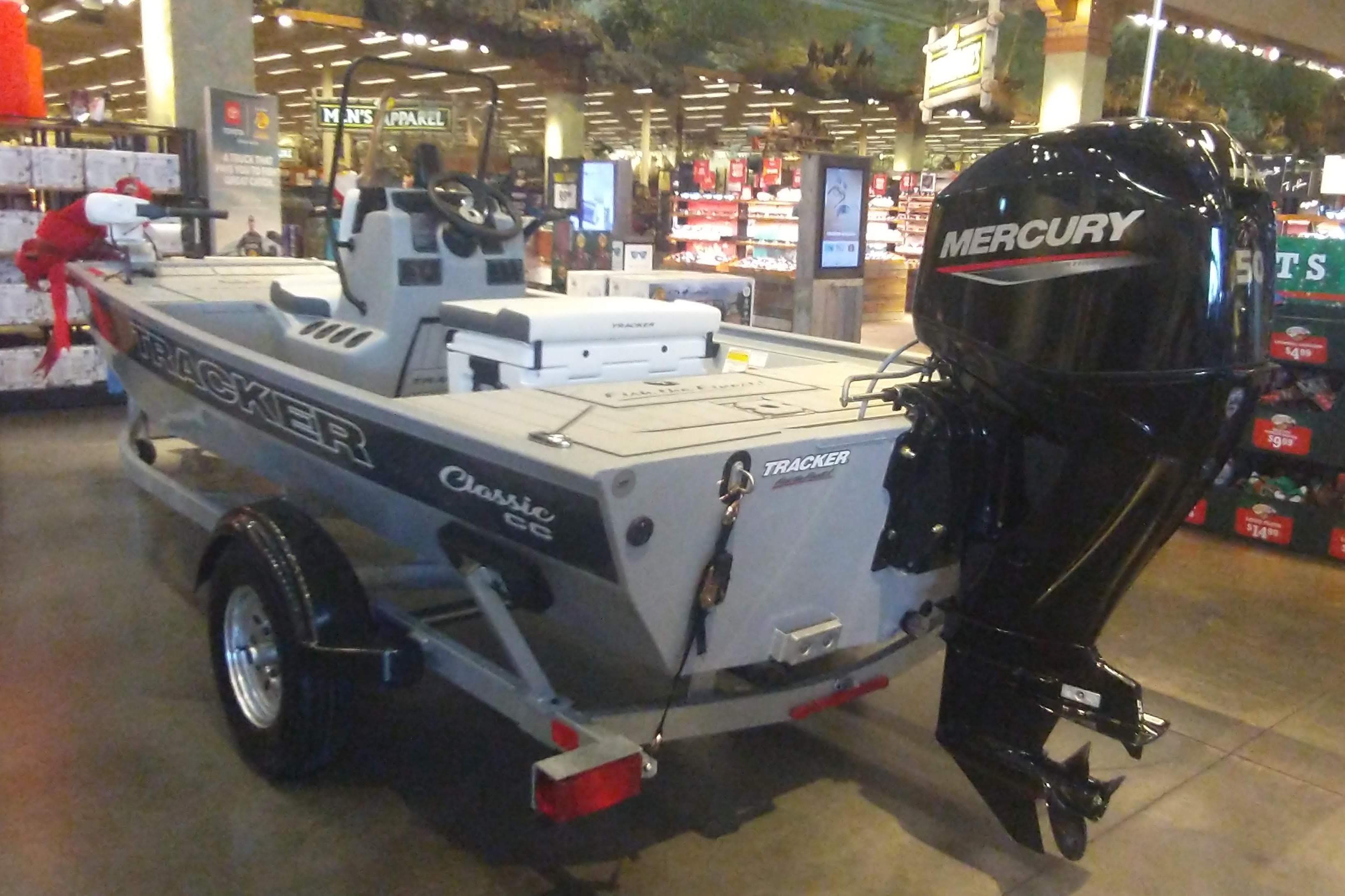 2026 Tracker Bass Tracker Classic CC boat with Mercury engine displayed indoors.