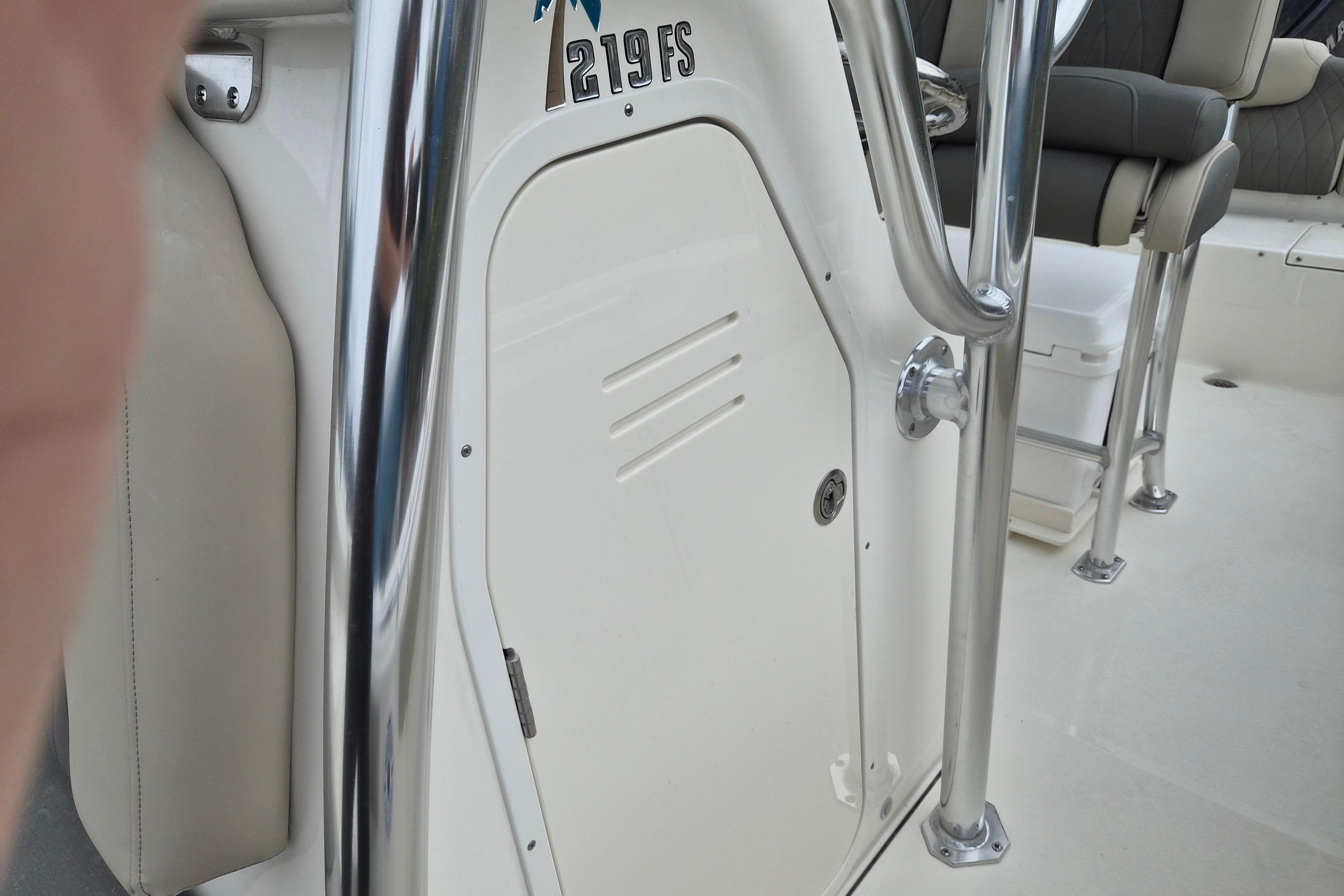 2026 Key West 219 FS boat interior with seating and stainless steel railing.