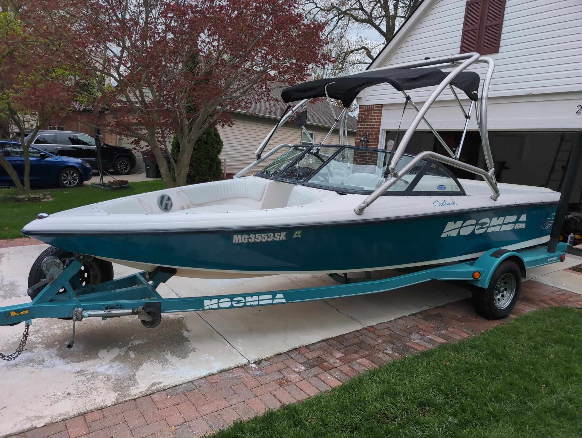 A 2000 Moomba Ouback LS on a trailer in a driveway.