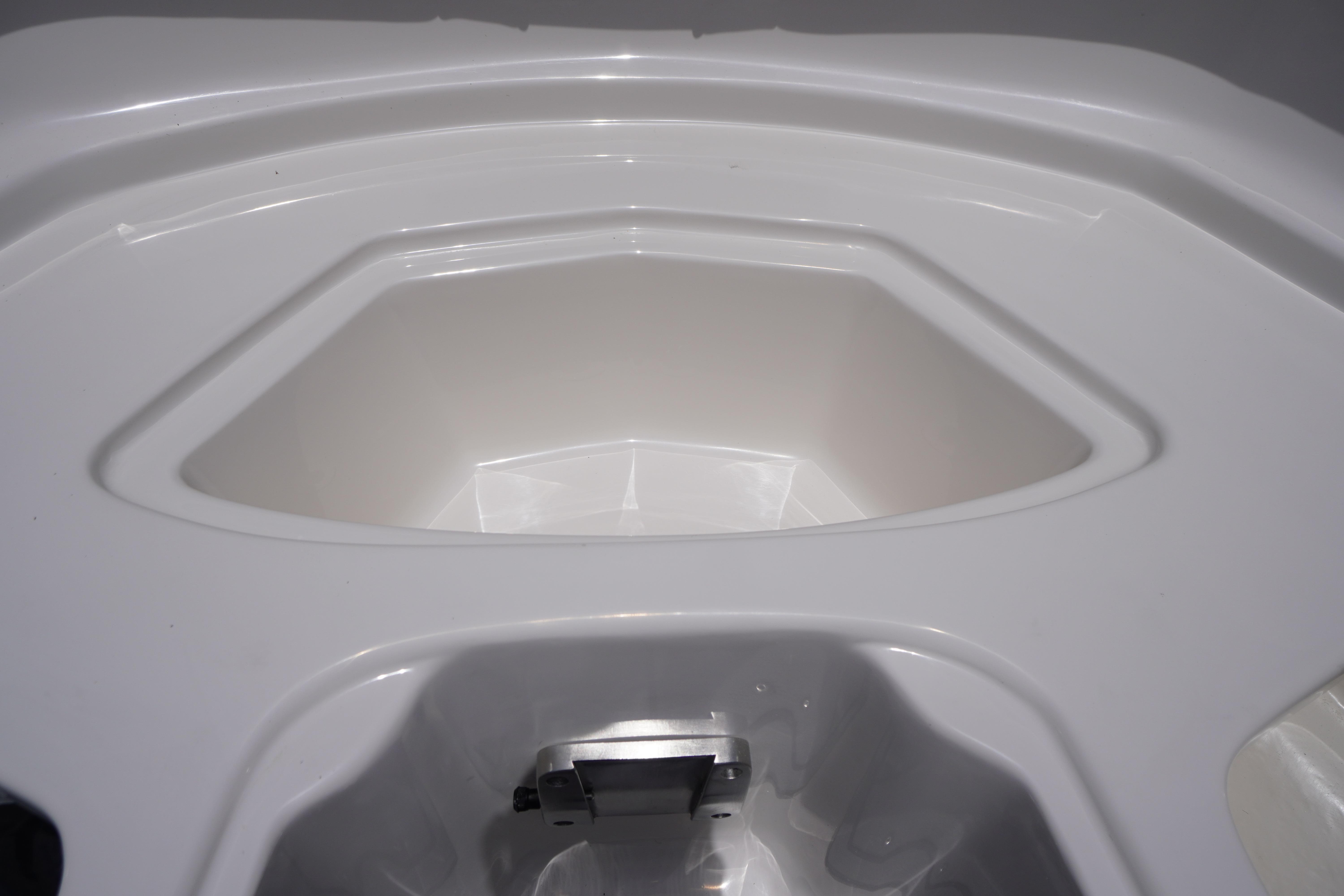2026 Chaparral 23 SSi OB boat interior detail, showcasing sleek white design and storage compartment.