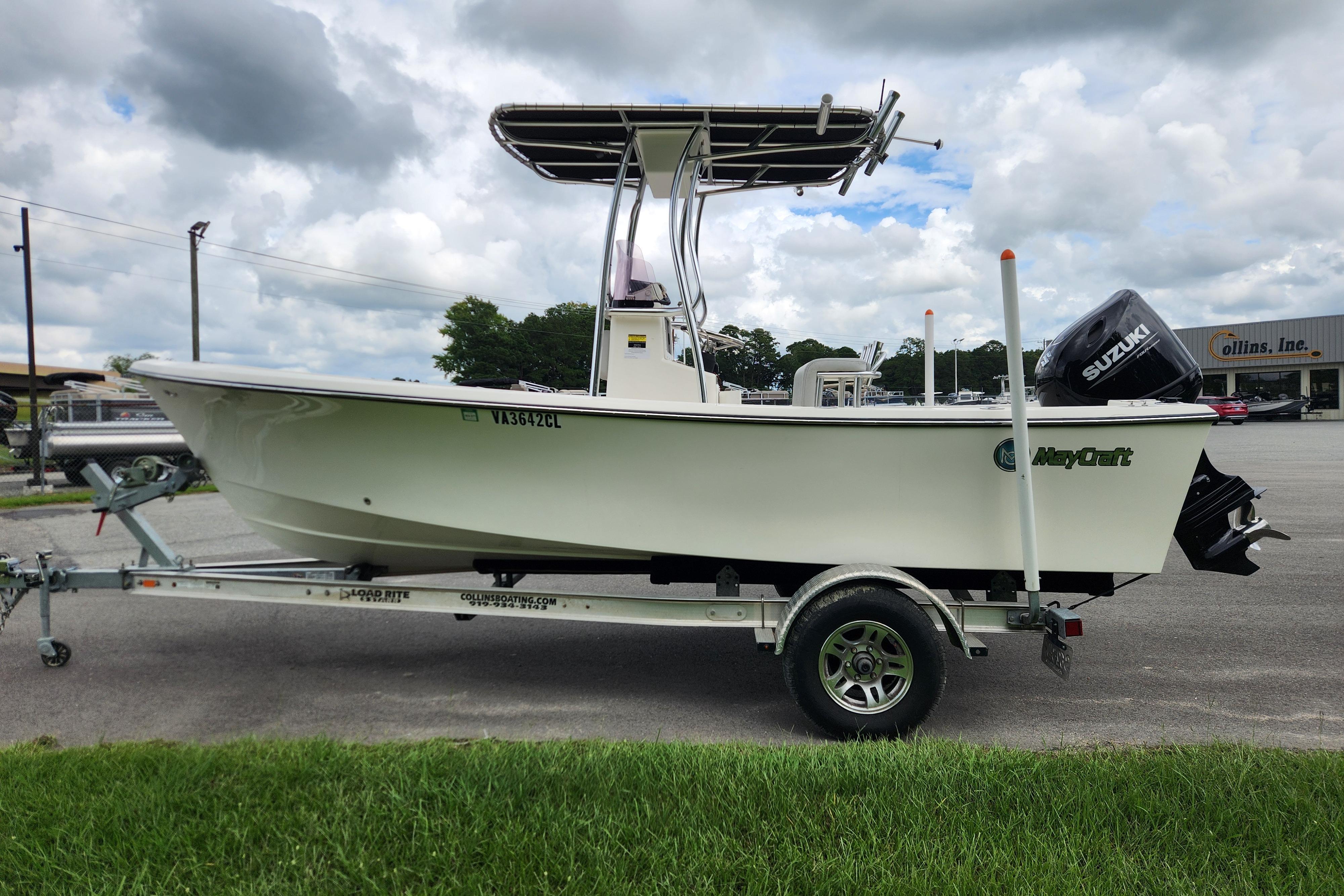 2023 May-Craft 1900CC boat on trailer with Suzuki outboard motor, parked outdoors.