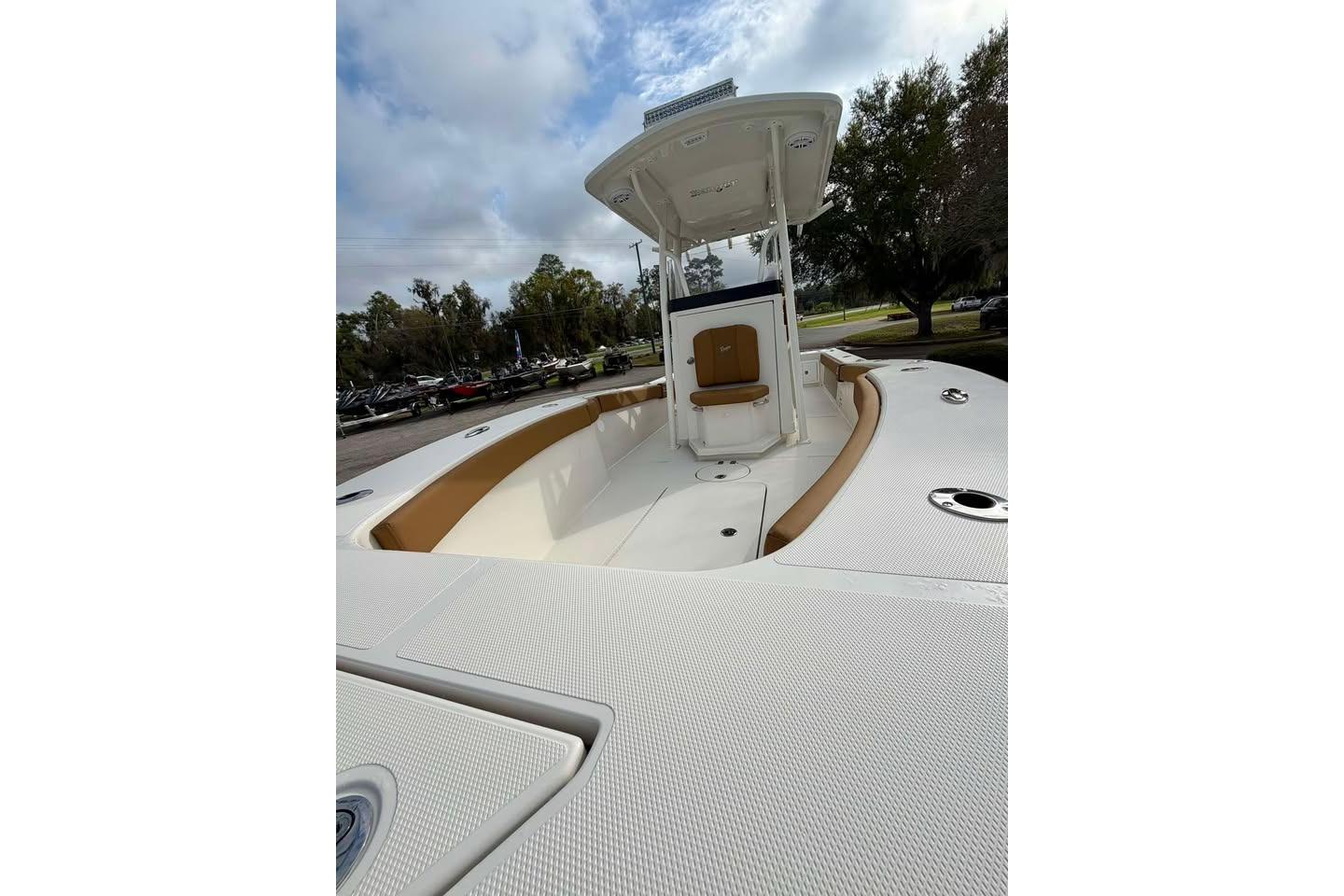 2026 Ranger 2600 Bay boat with spacious deck and seating, under a cloudy sky.