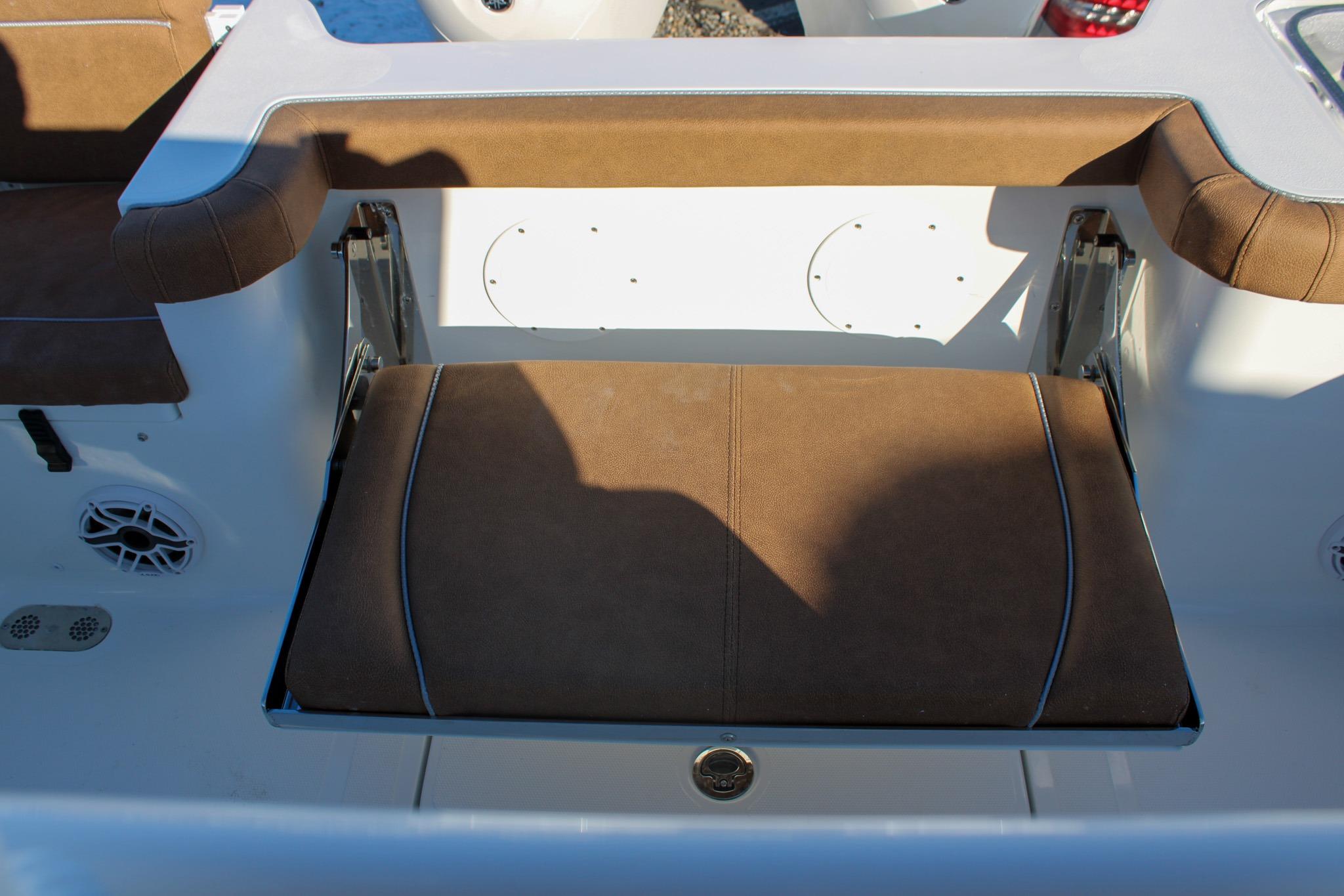 2026 Sea Hunt Gamefish 25 boat seat with brown upholstery and white accents.