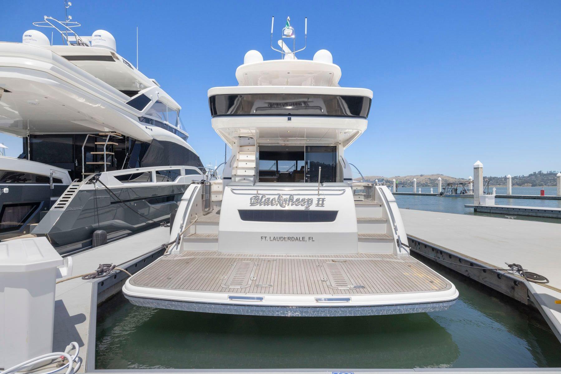 2015 Princess 60 Flybridge Motor Yacht docked at marina, rear view.