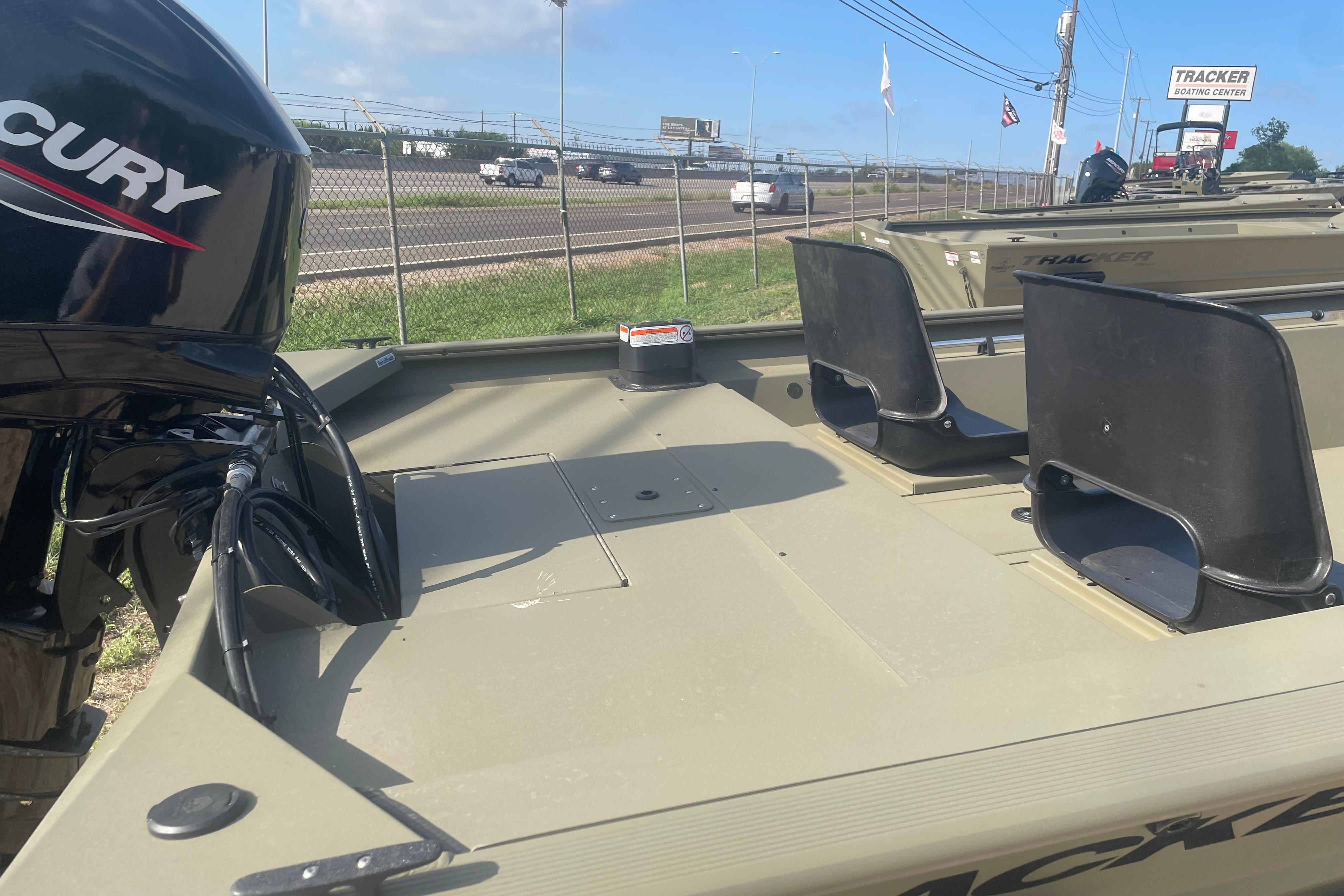 2026 Tracker Grizzly 1754 SC boat with Mercury engine, displayed at a boating center.