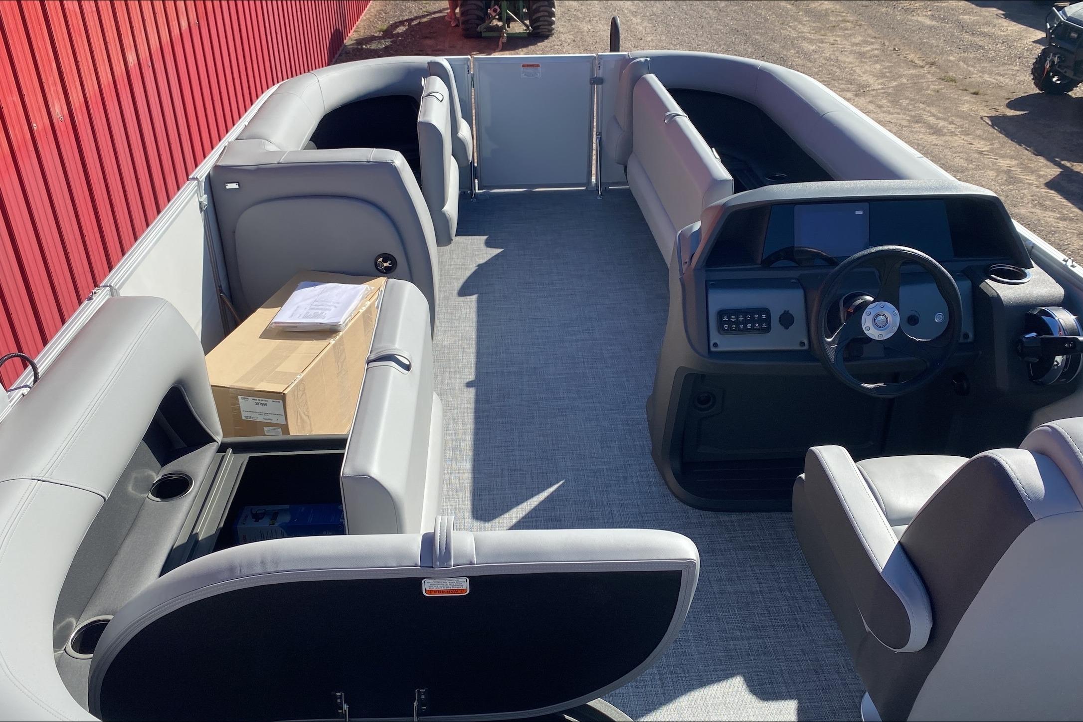 2026 Sun Tracker Party Barge 18 DLX interior with seating and steering console.