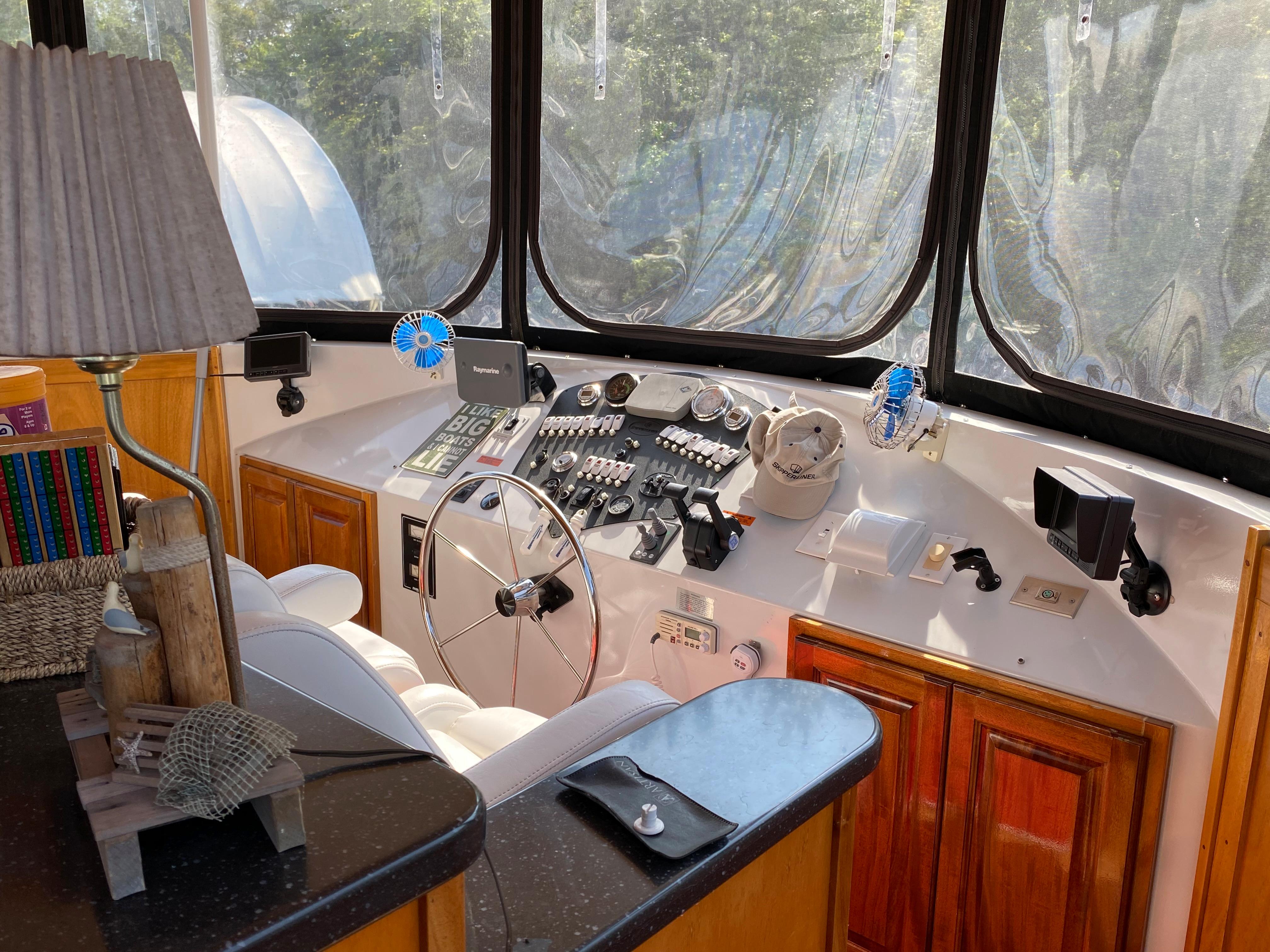 2005 Skipperliner Millenium helm with steering wheel, controls, and wooden cabinetry.