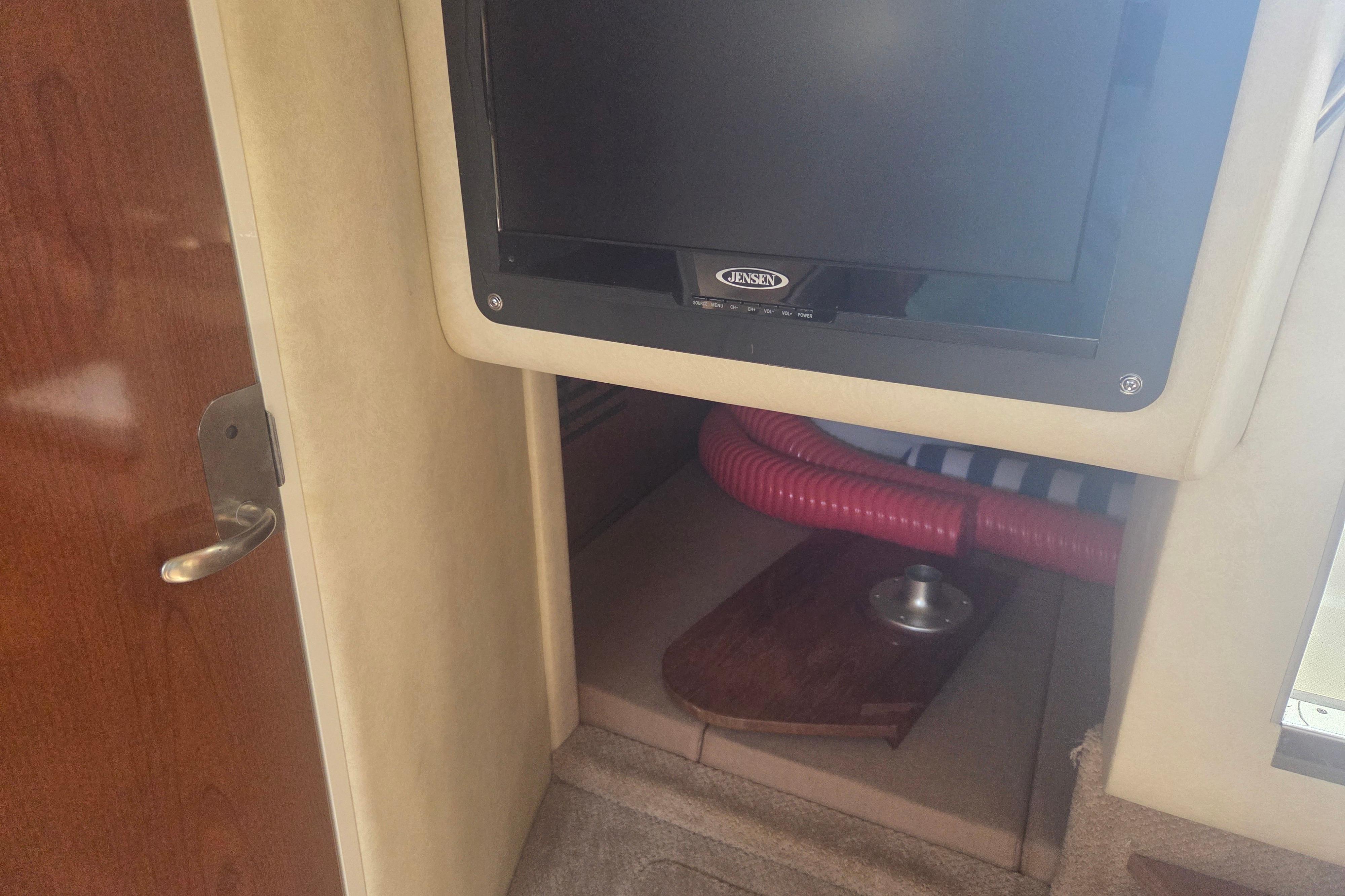 Interior of 2012 Sea Ray Sundancer 260 with TV and cabin space.