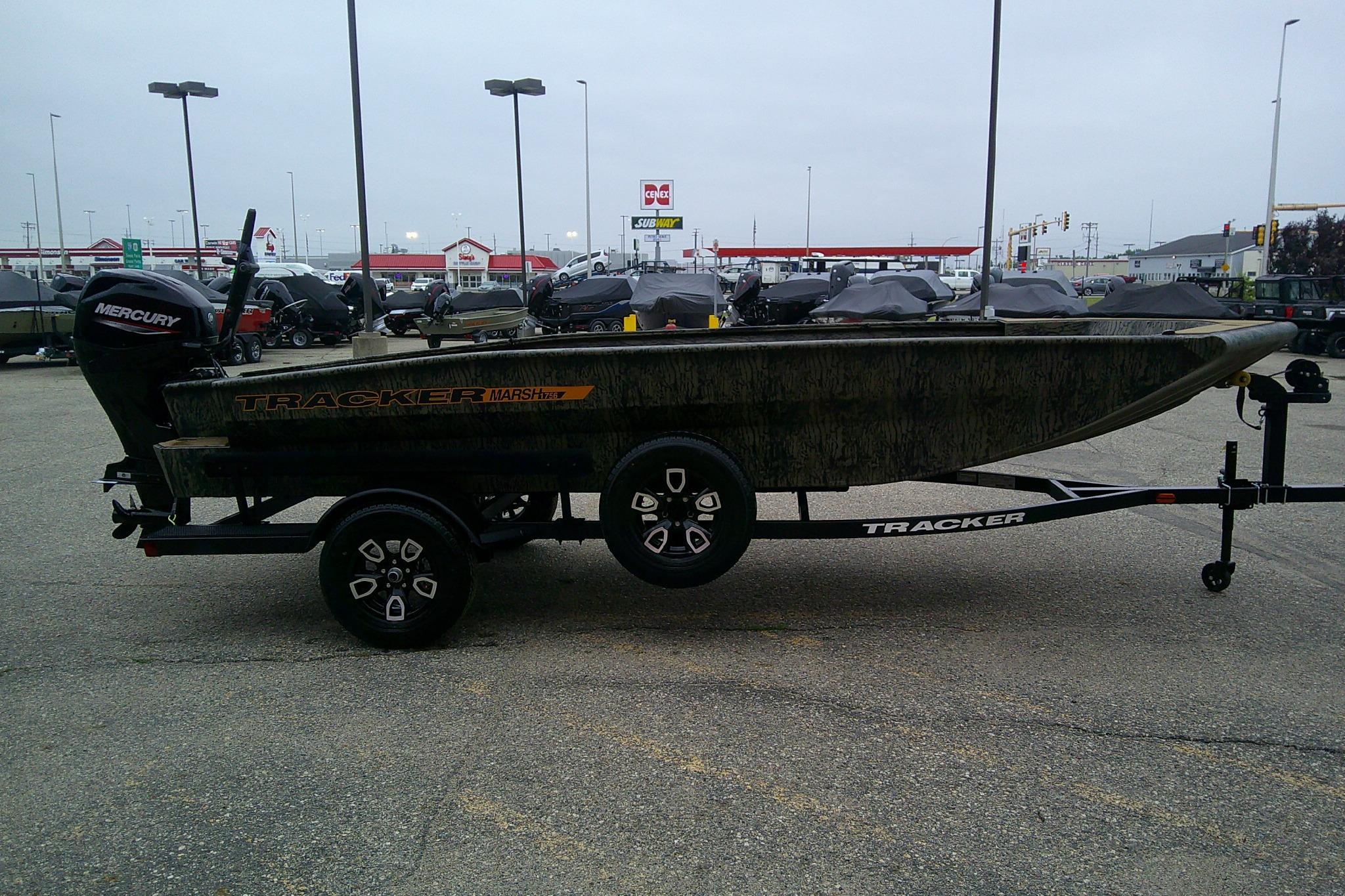 2026 Tracker Grizzly 1756 T Marsh boat on trailer in parking lot.
