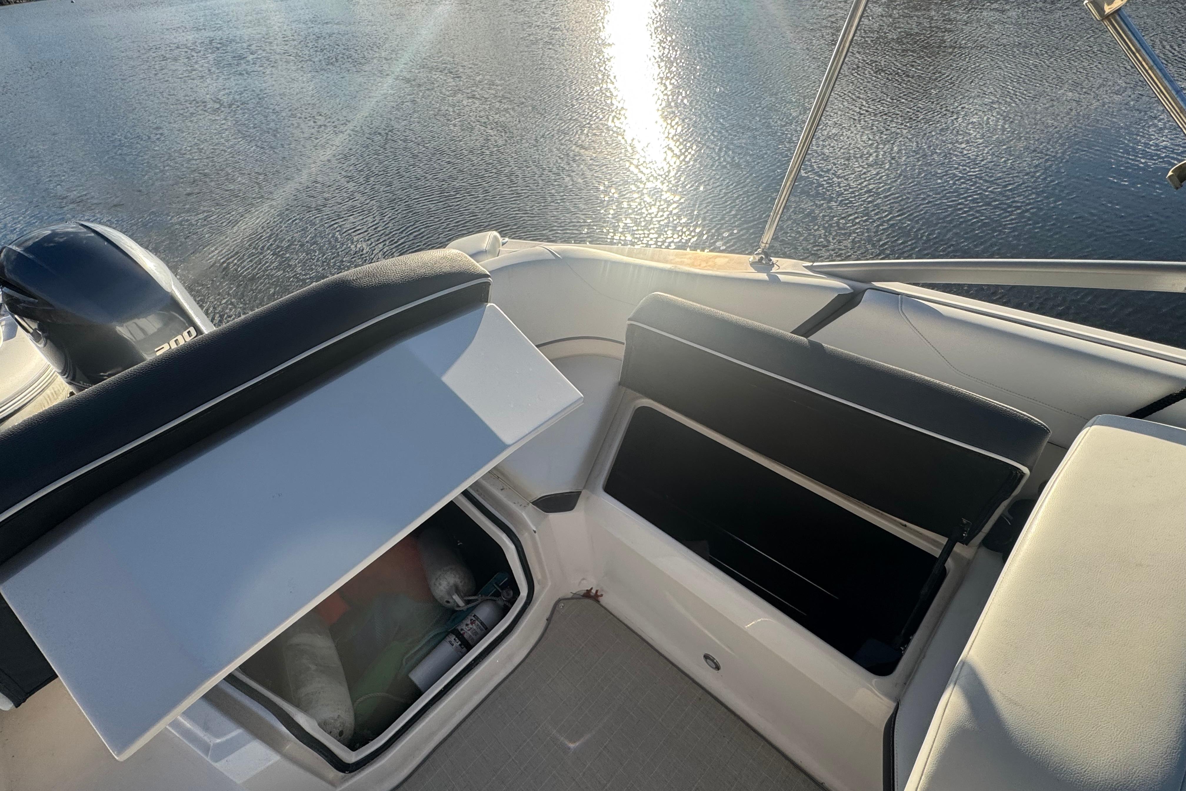 2017 Regal 23 OBX boat interior with open storage compartments on a sunny day.