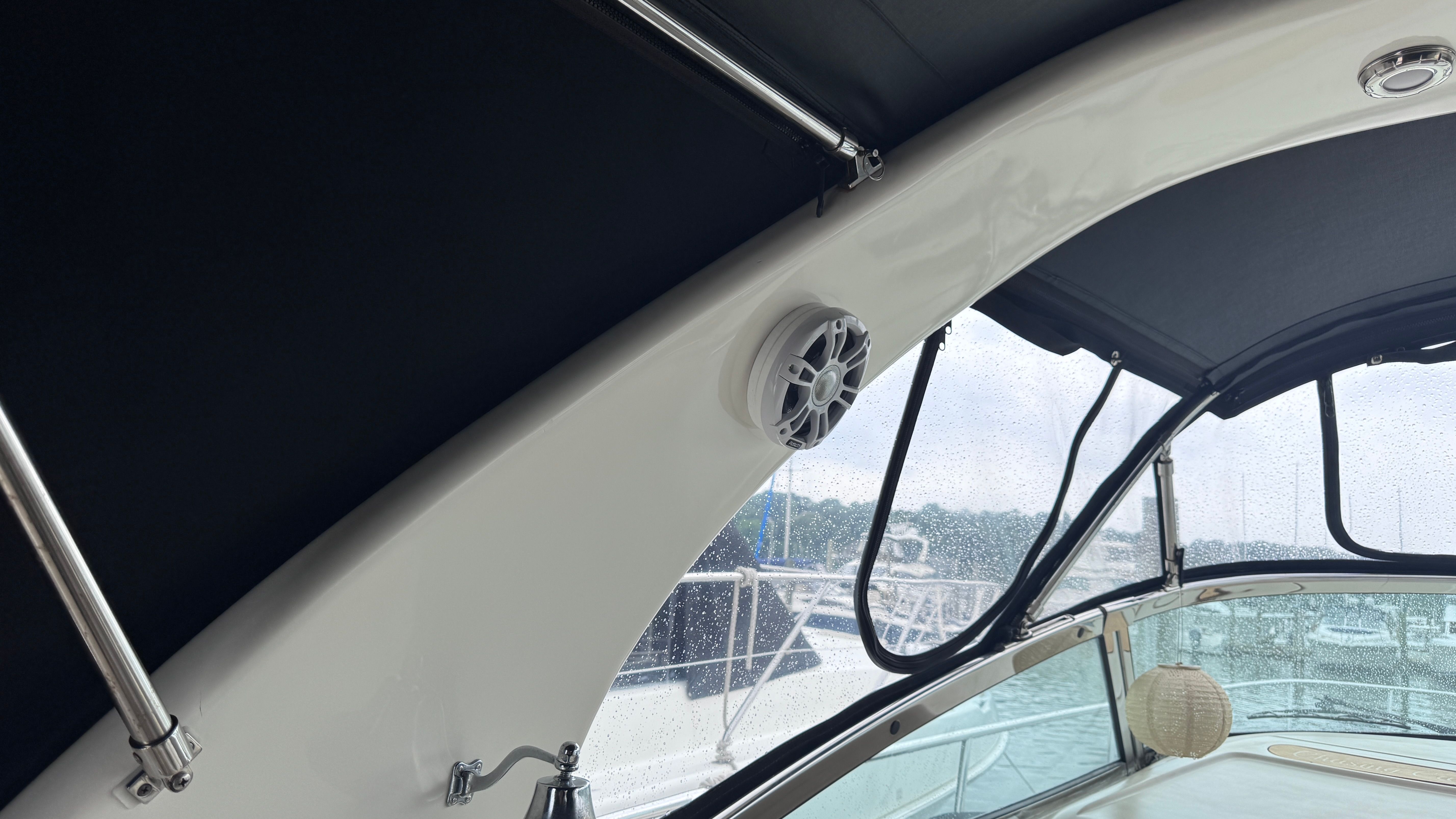 Interior view of a Sea Ray 360 Sundancer with speaker and canopy.