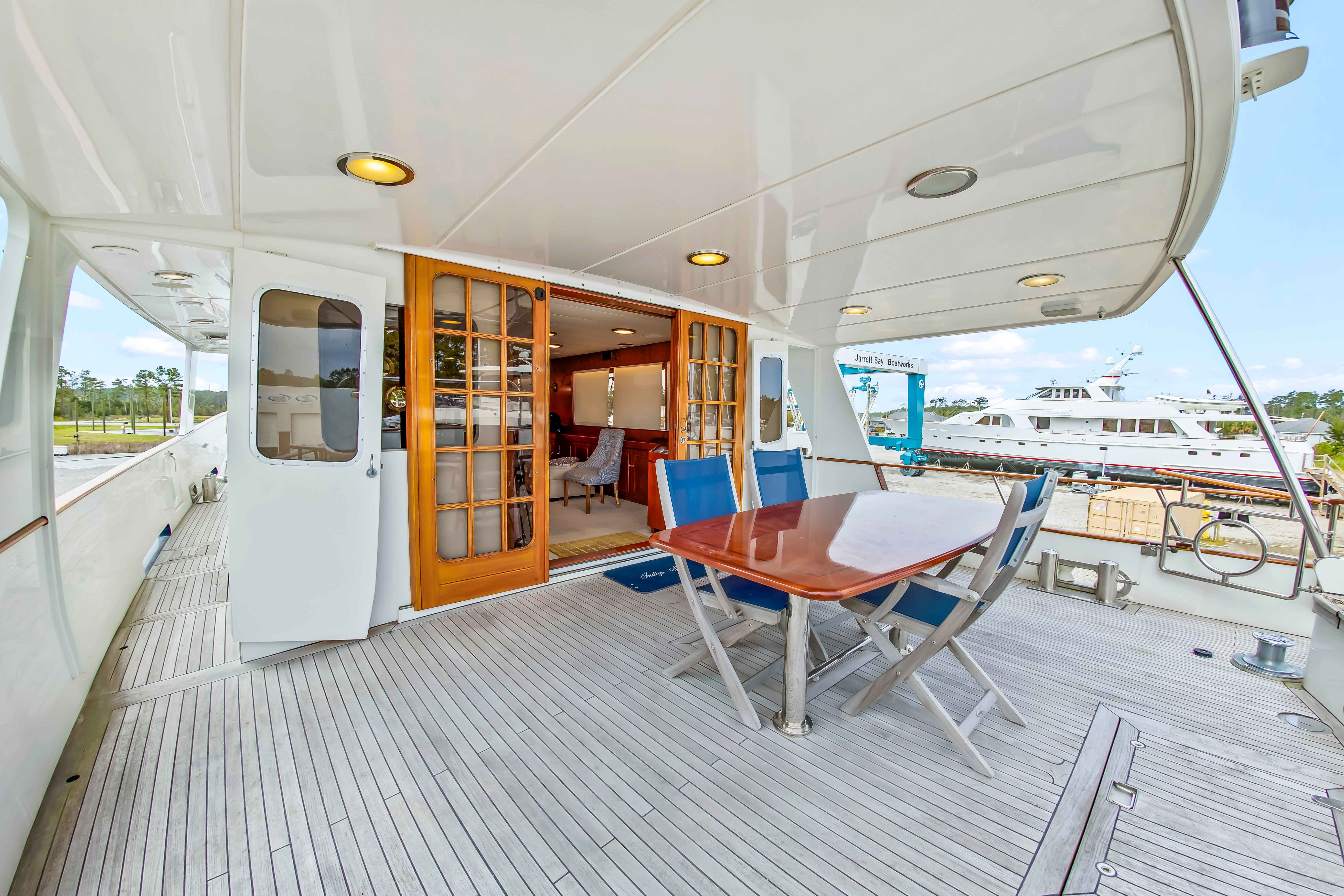 Deck area of a 1987 Jongert 78 Motor Yacht with table and chairs.