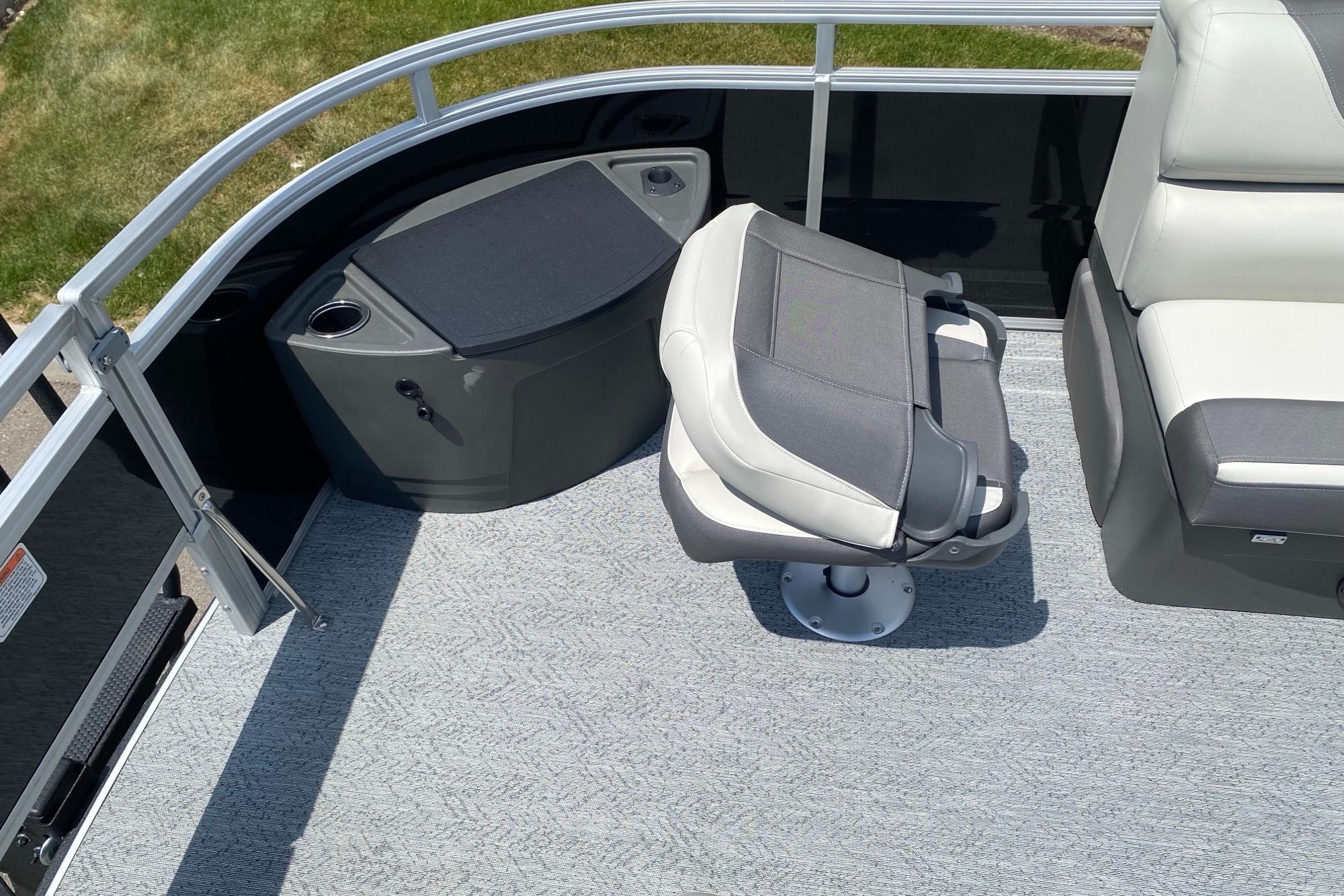 2026 Sun Tracker Fishin' Barge 20 DLX interior with seating and storage features.