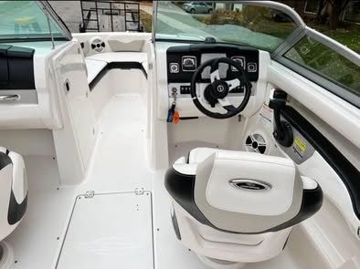 The image shows the cockpit of a 2010 Chaparral 216 SSi boat with a modern helm.