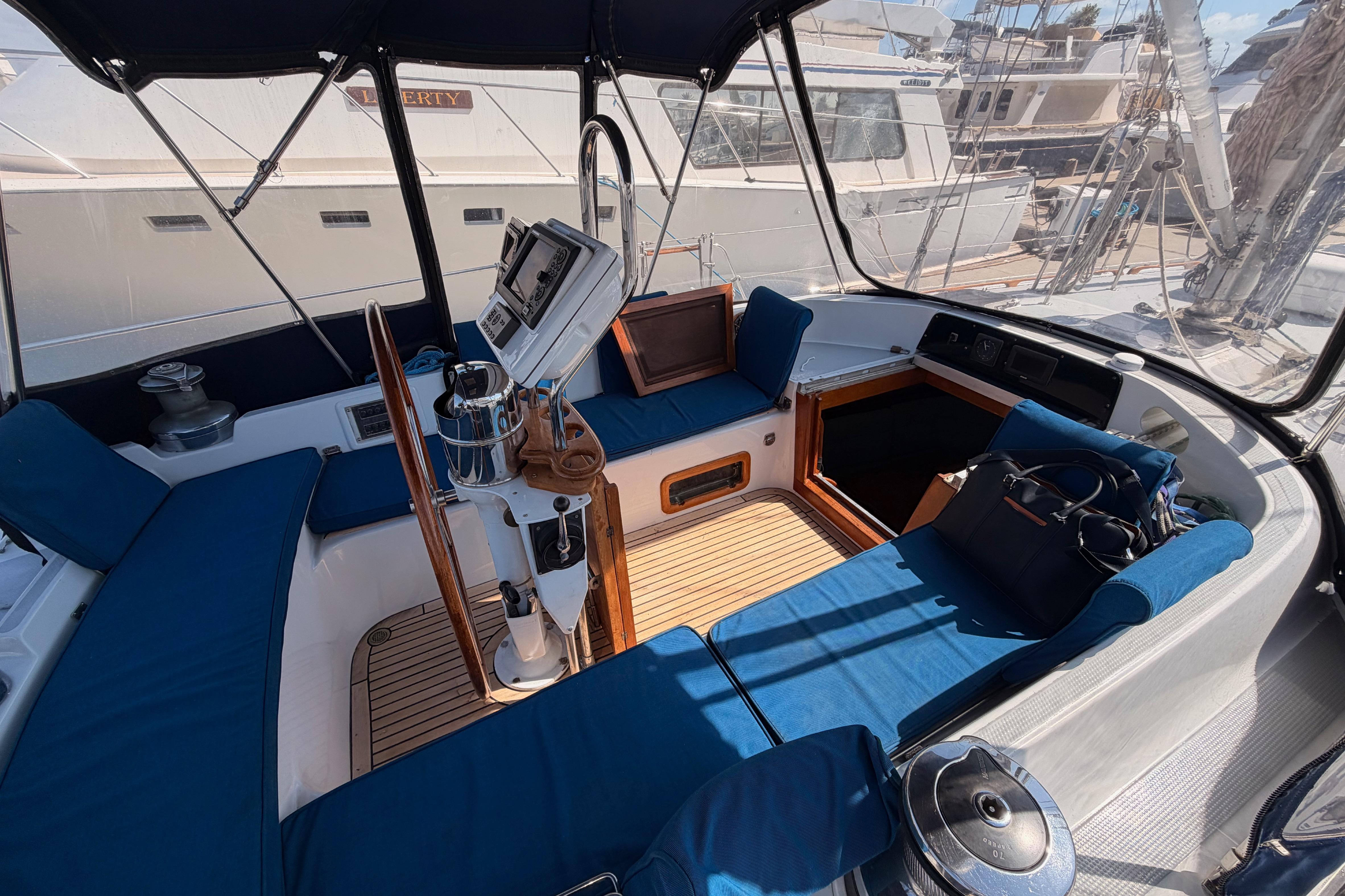 Cockpit of a 1991 Hylas 51 yacht with blue seating and navigation equipment.