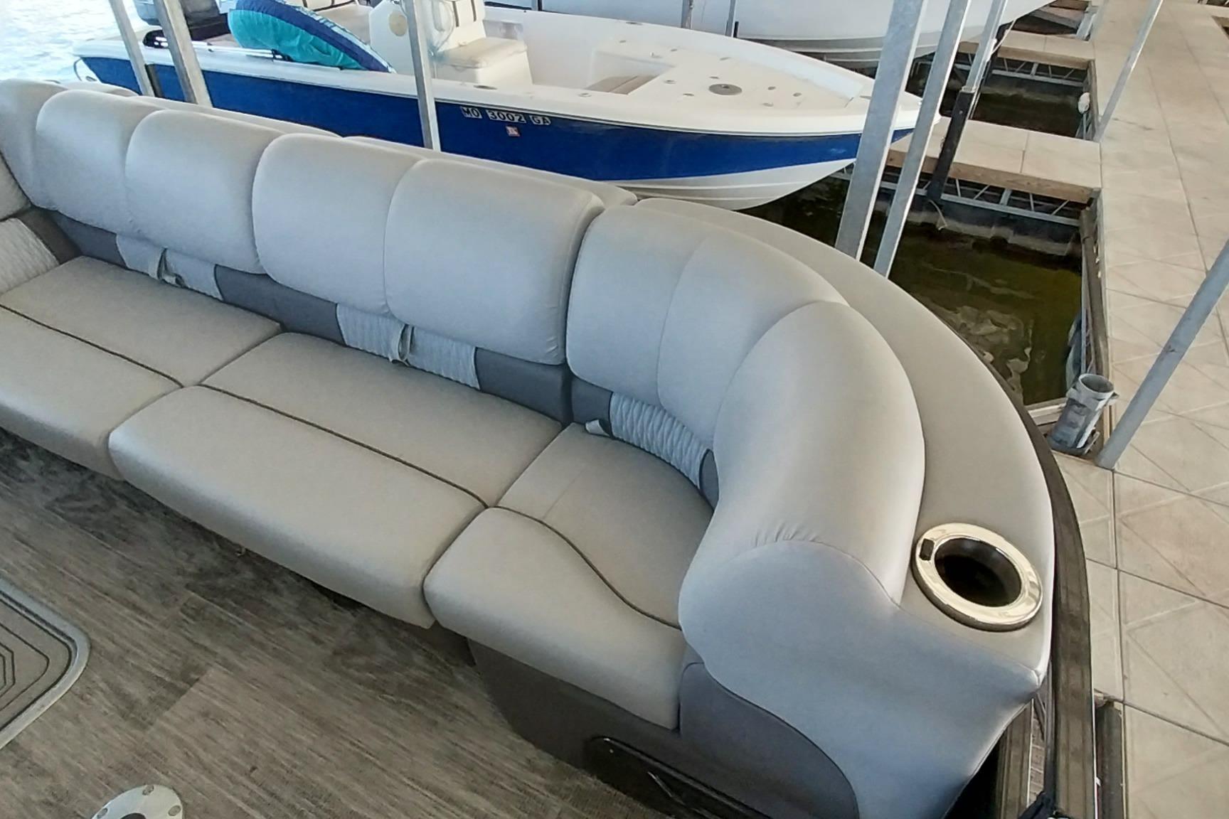 Luxurious seating on 2023 Ranger 2500LS boat, featuring plush upholstery and cup holder.