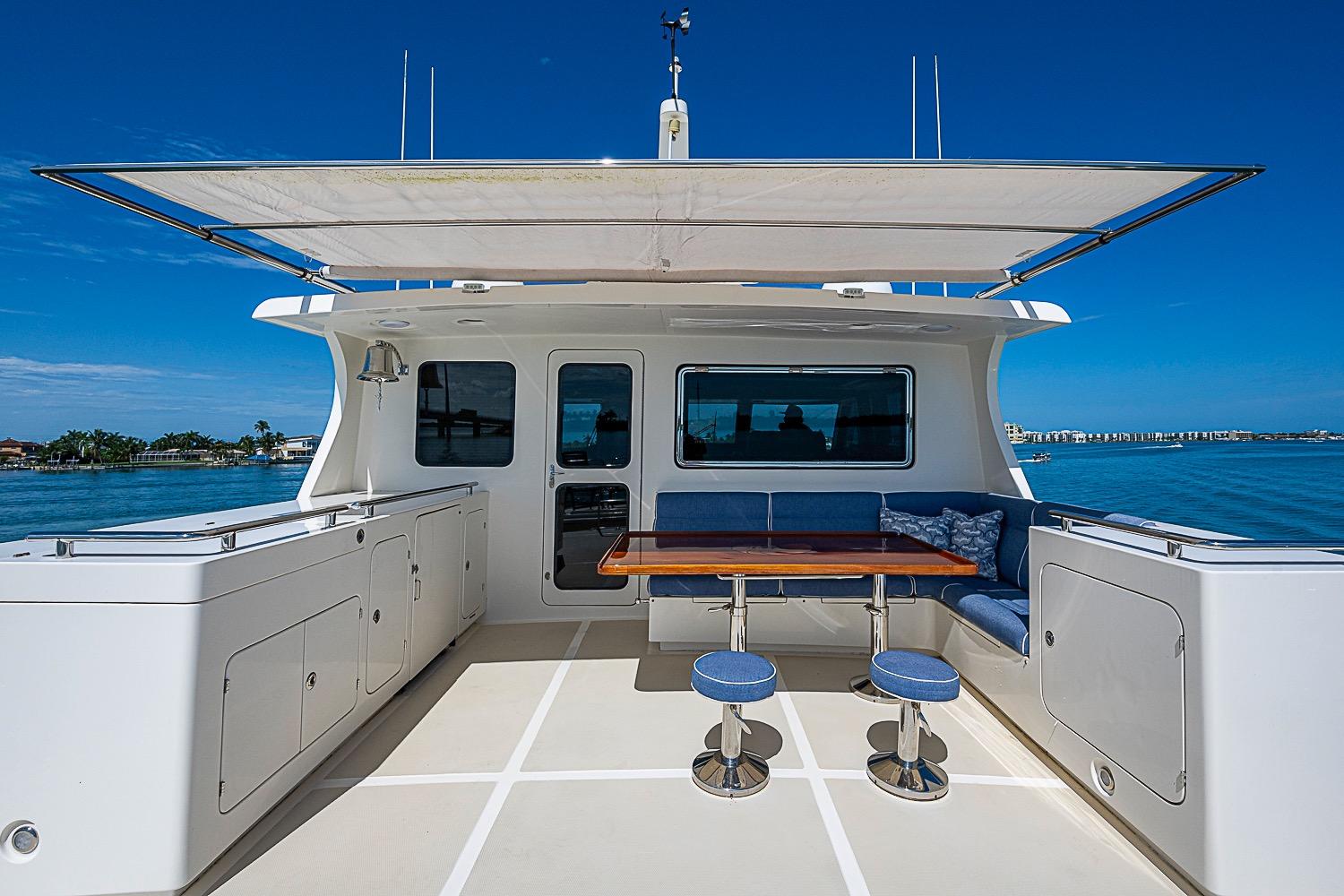 Luxury deck of 2014 Marlow 80 Explorer yacht with seating and table.