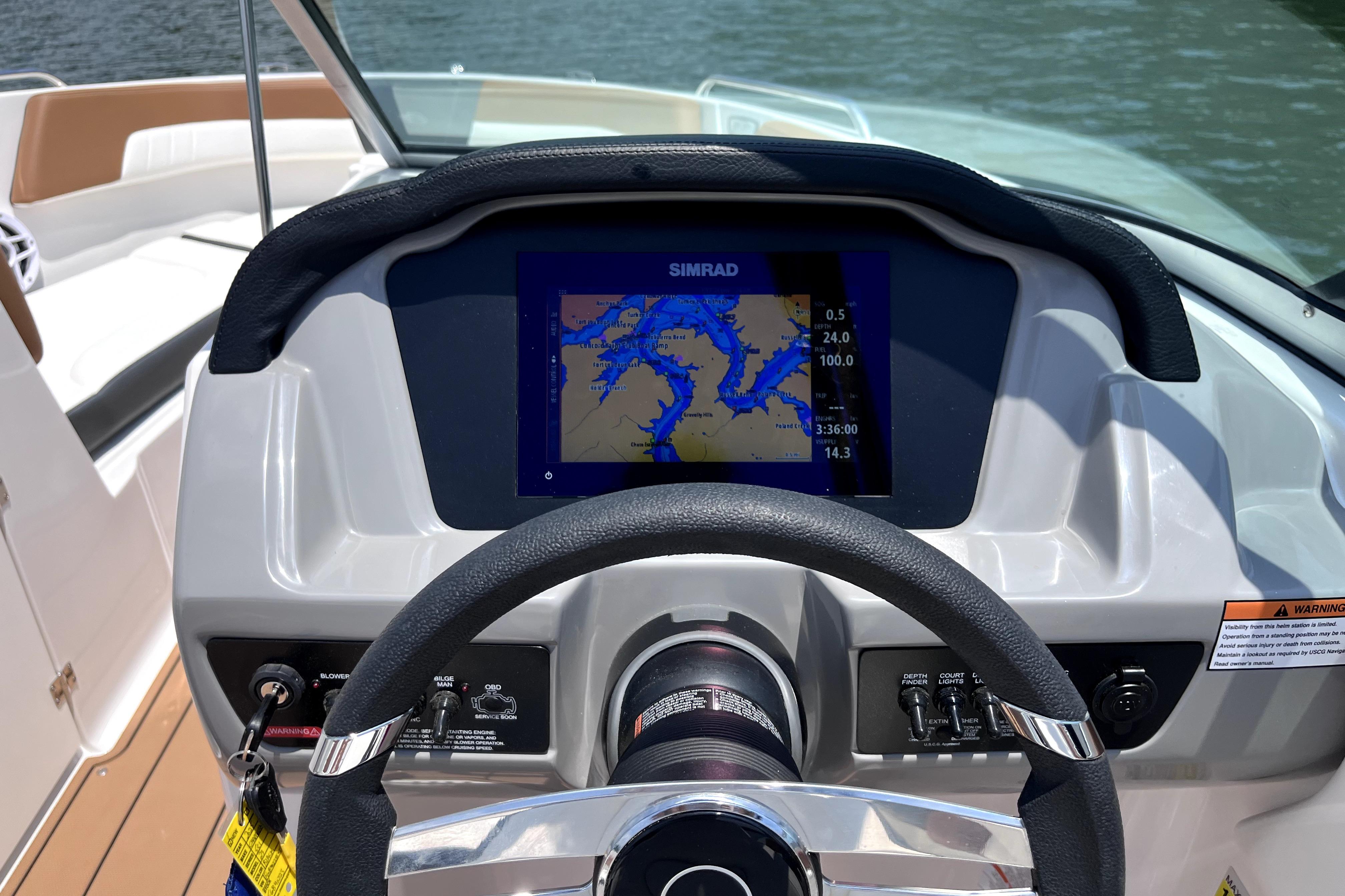 Steering wheel and navigation display of 2025 Chaparral 230 SSi boat.