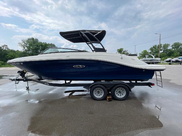 2023 Sea Ray SPX 230 boat on trailer, side view, under cloudy sky.