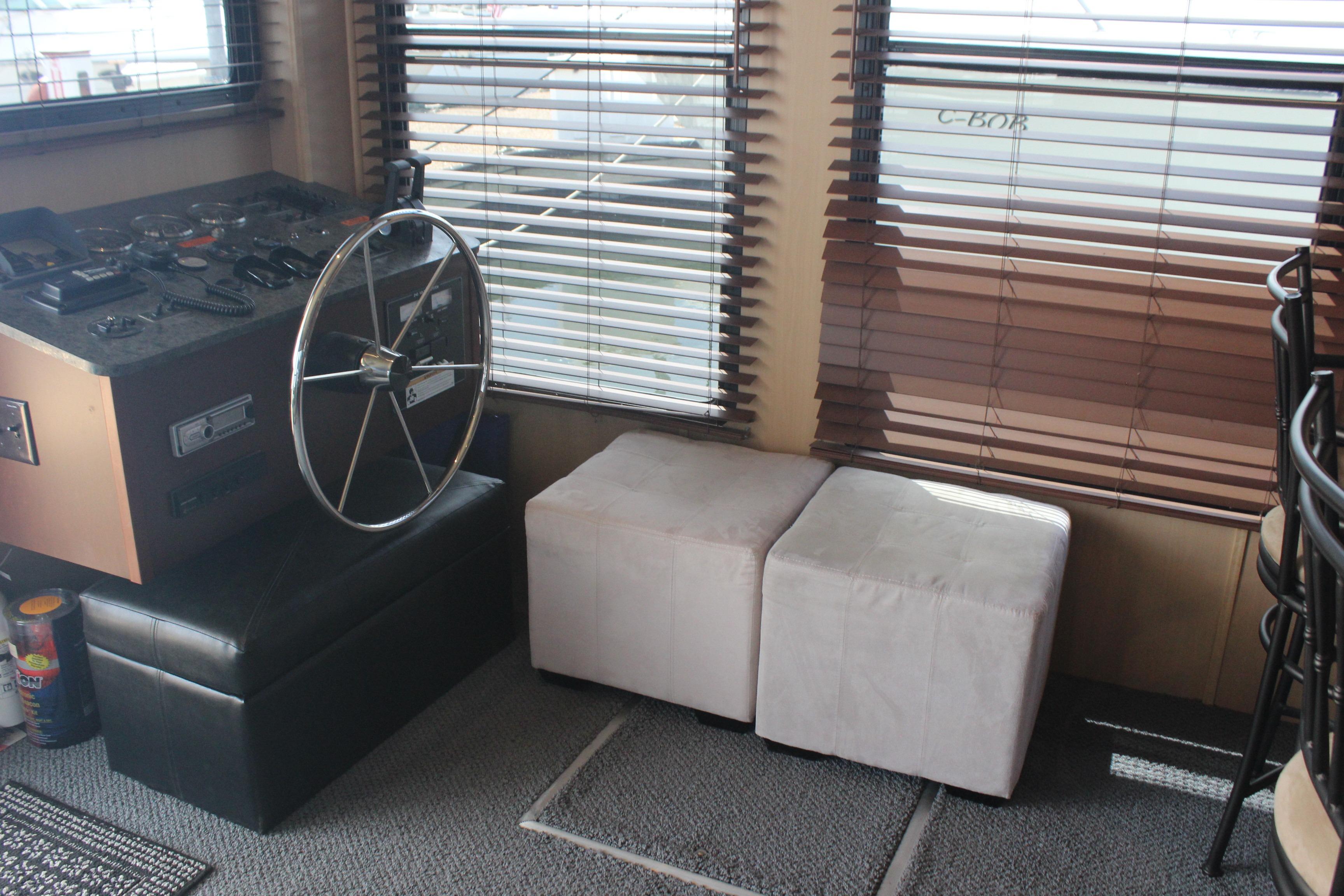 Interior of 2010 Skipperliner 480 Flybridge with helm and seating area.