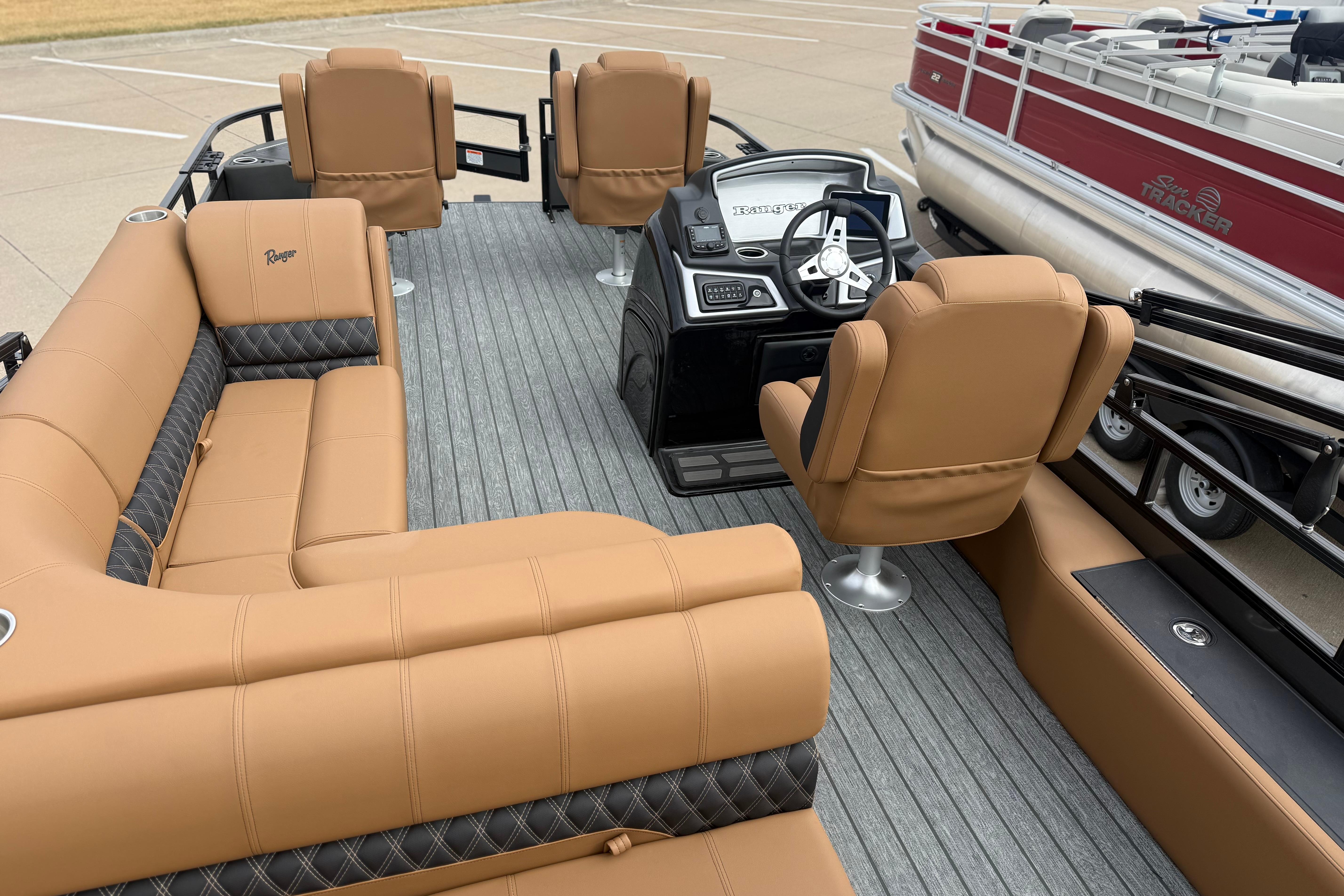 Luxurious interior of 2026 Ranger 220F boat with tan seating and modern dashboard.