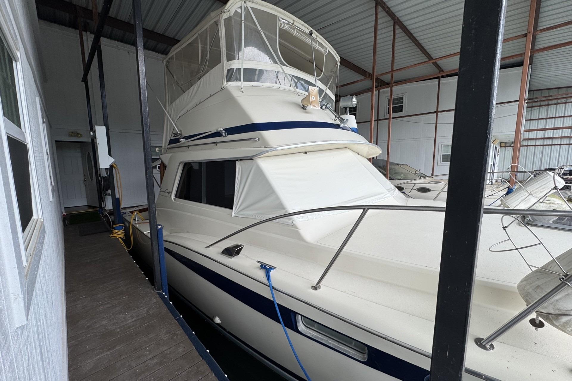 1980 Chris-Craft 360 Commander yacht docked in a covered marina.