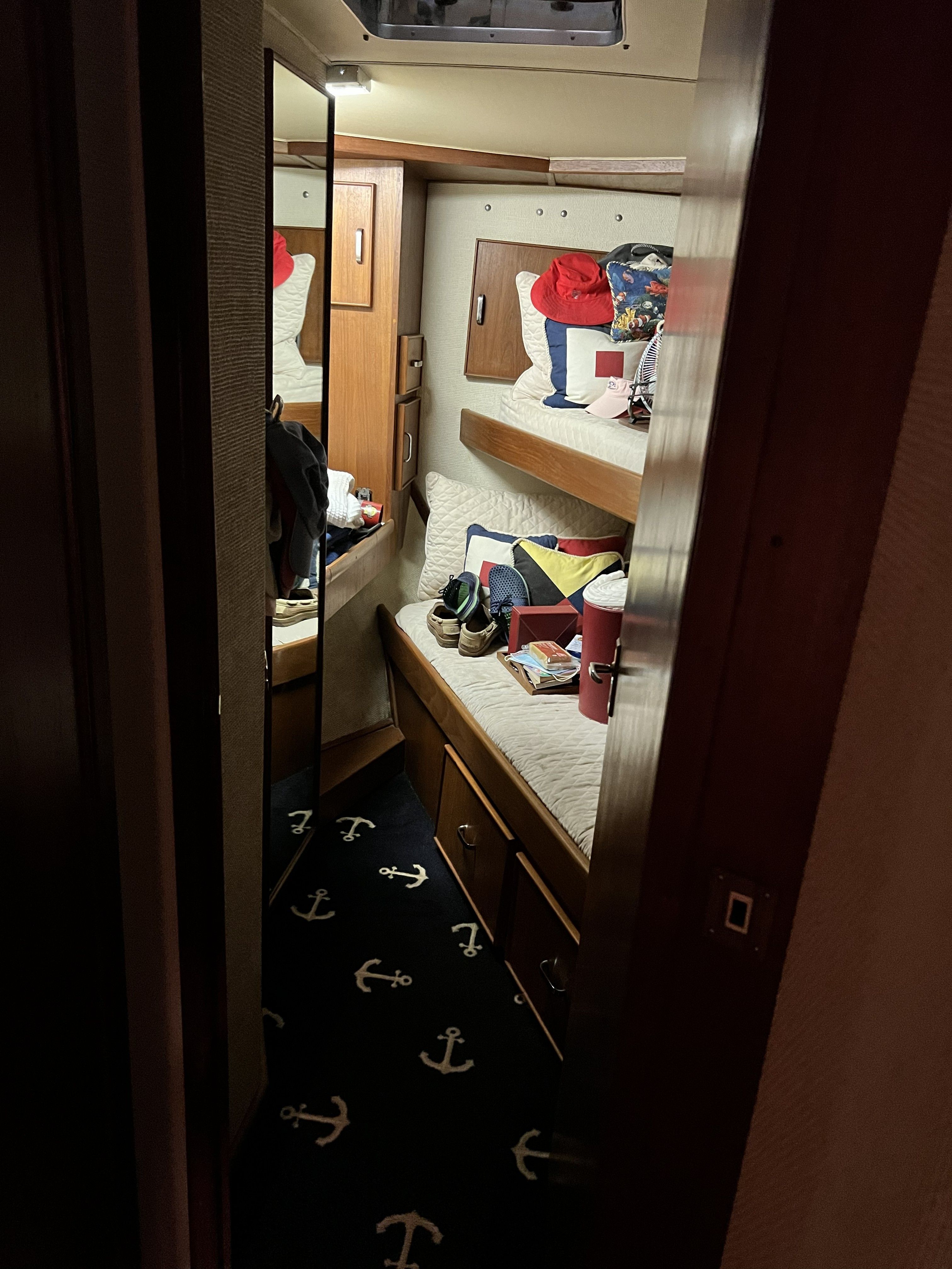 Interior of a 1979 Chris-Craft 45 TF with a cozy cabin and anchor-patterned carpet.