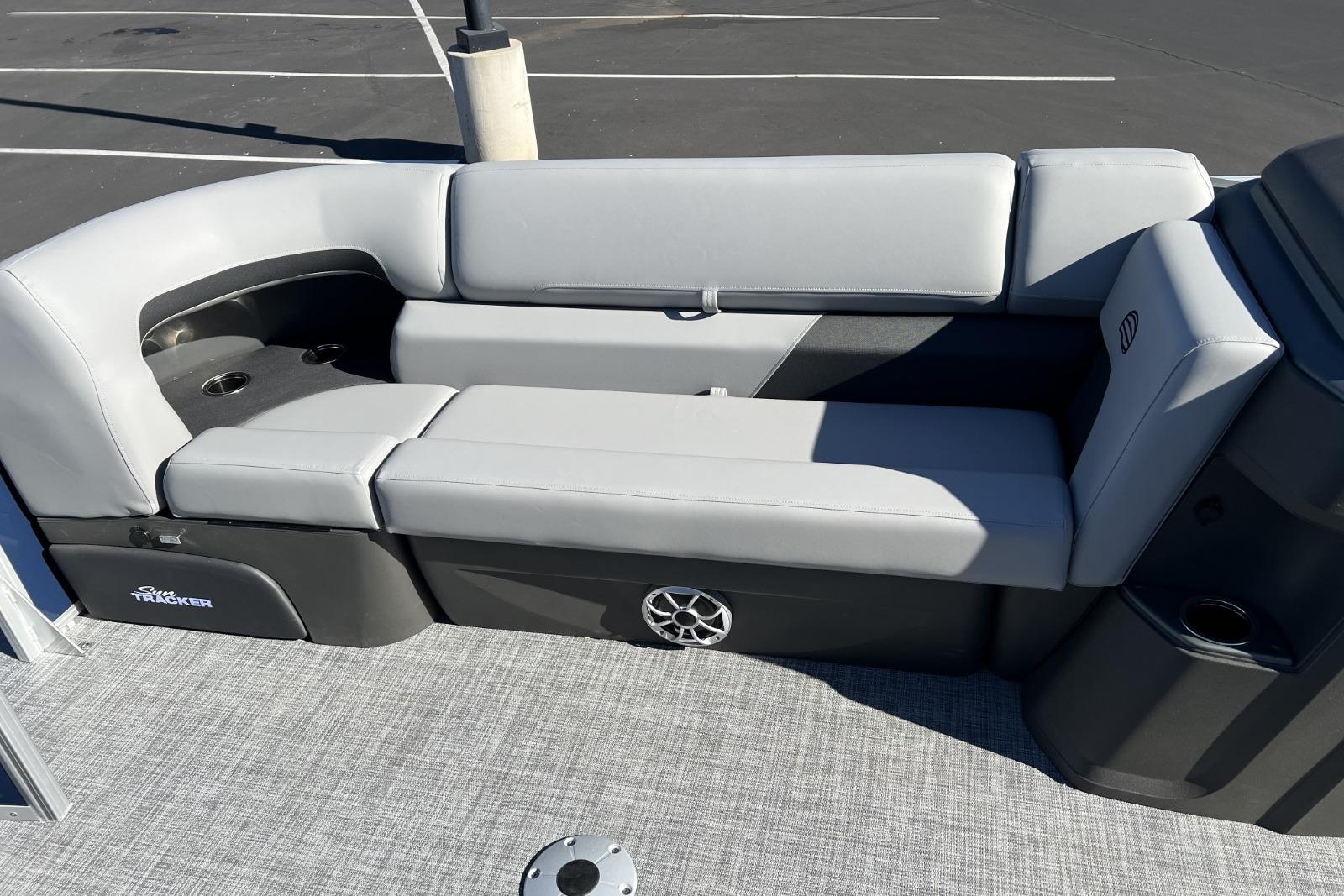 2026 Sun Tracker SportFish 22 DLX boat interior with gray seating and cup holders.