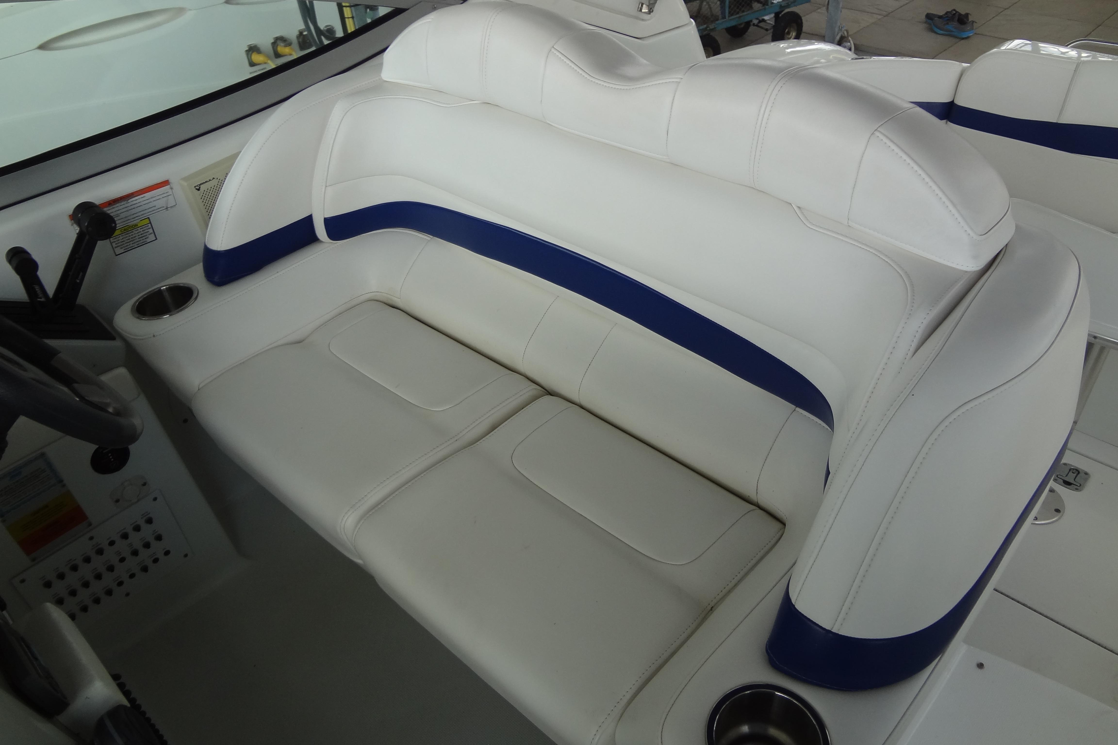 White leather seating on 2007 Formula 34 Performance Cruiser boat, featuring blue accents and cup holders.